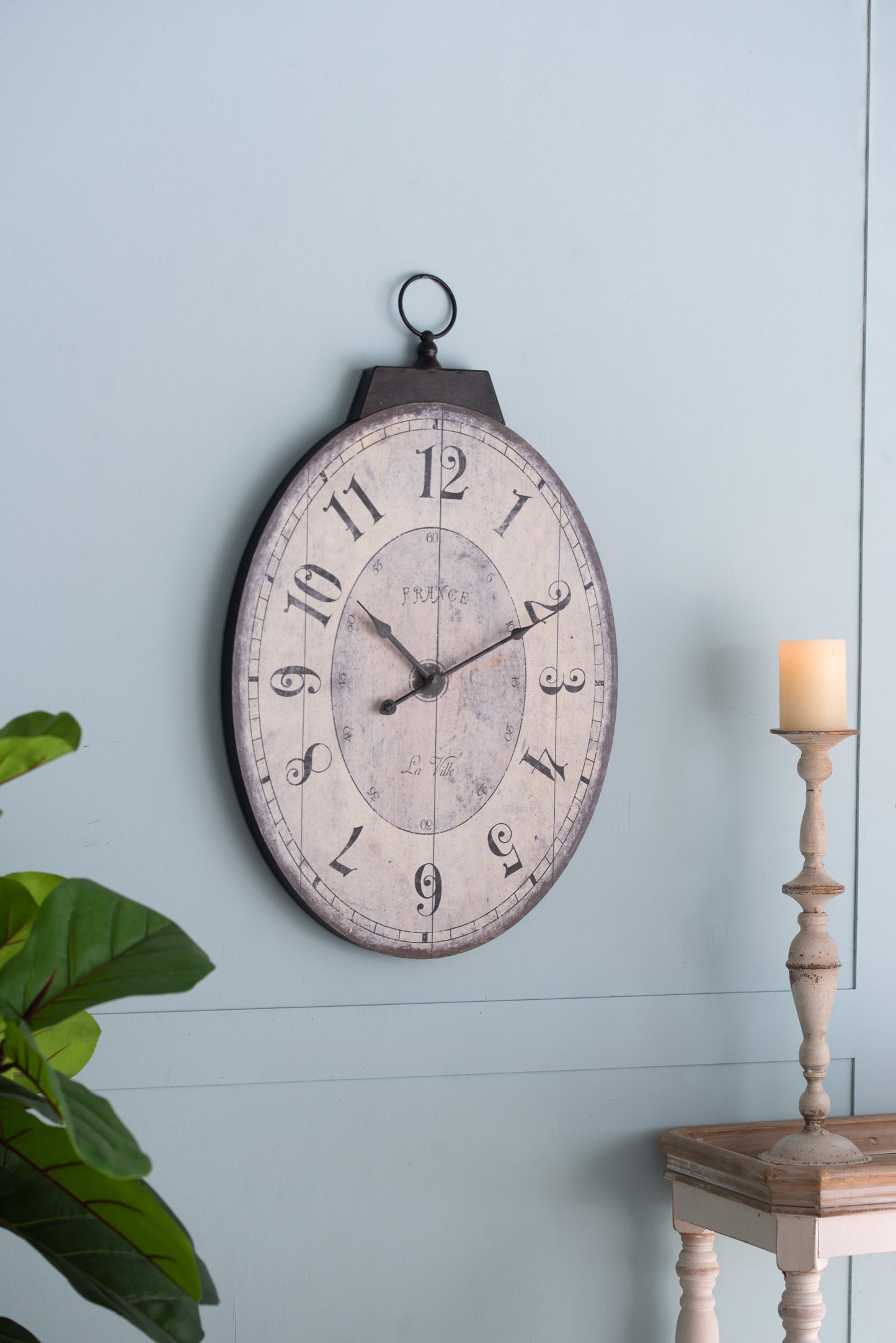 Rustic oval wall clock with distressed finish and France text