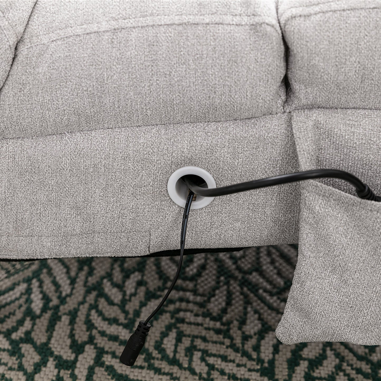 Gray recliner sofa base with integrated power cord grommet detail