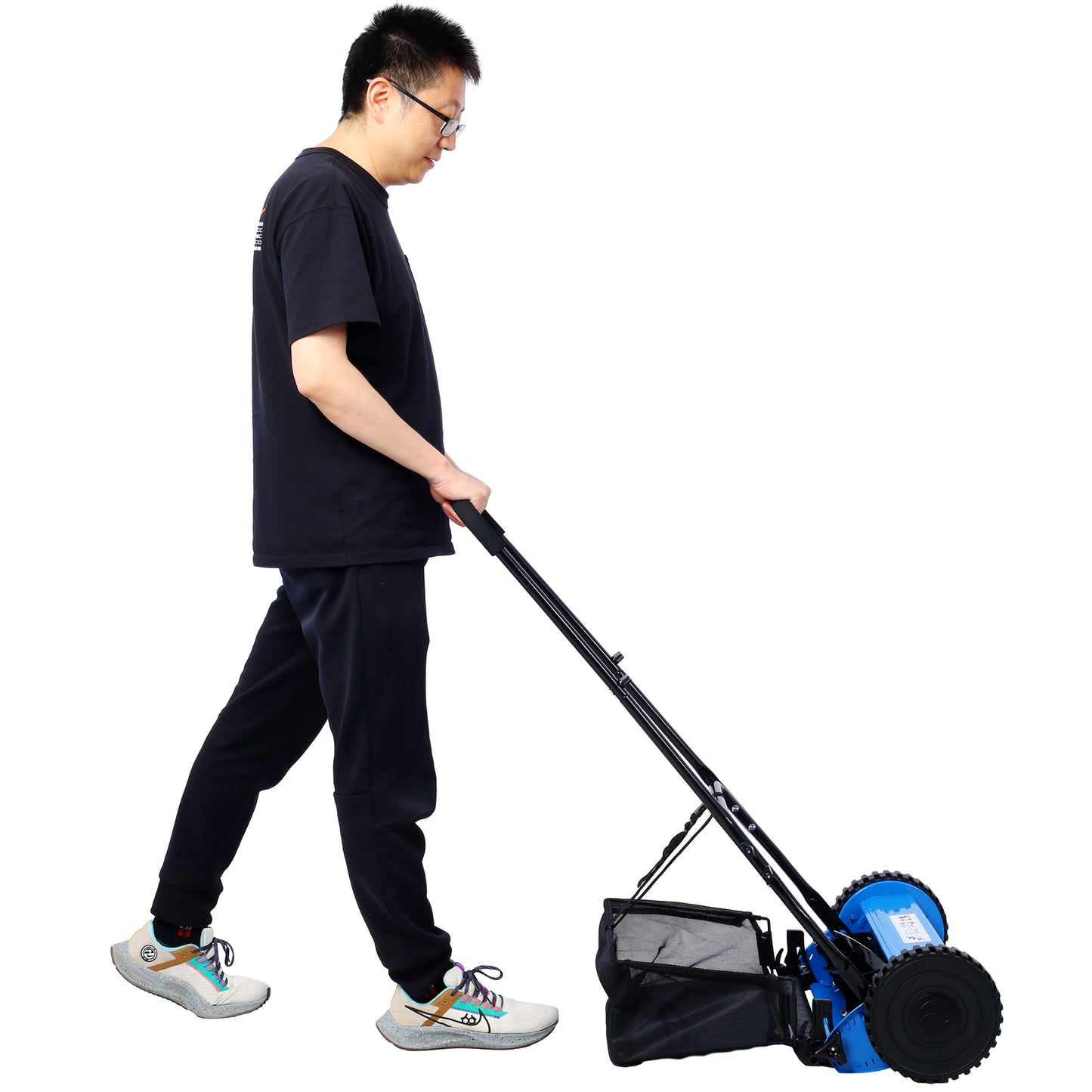 Blue push reel mower with grass catcher bag operated by man in black tshirt