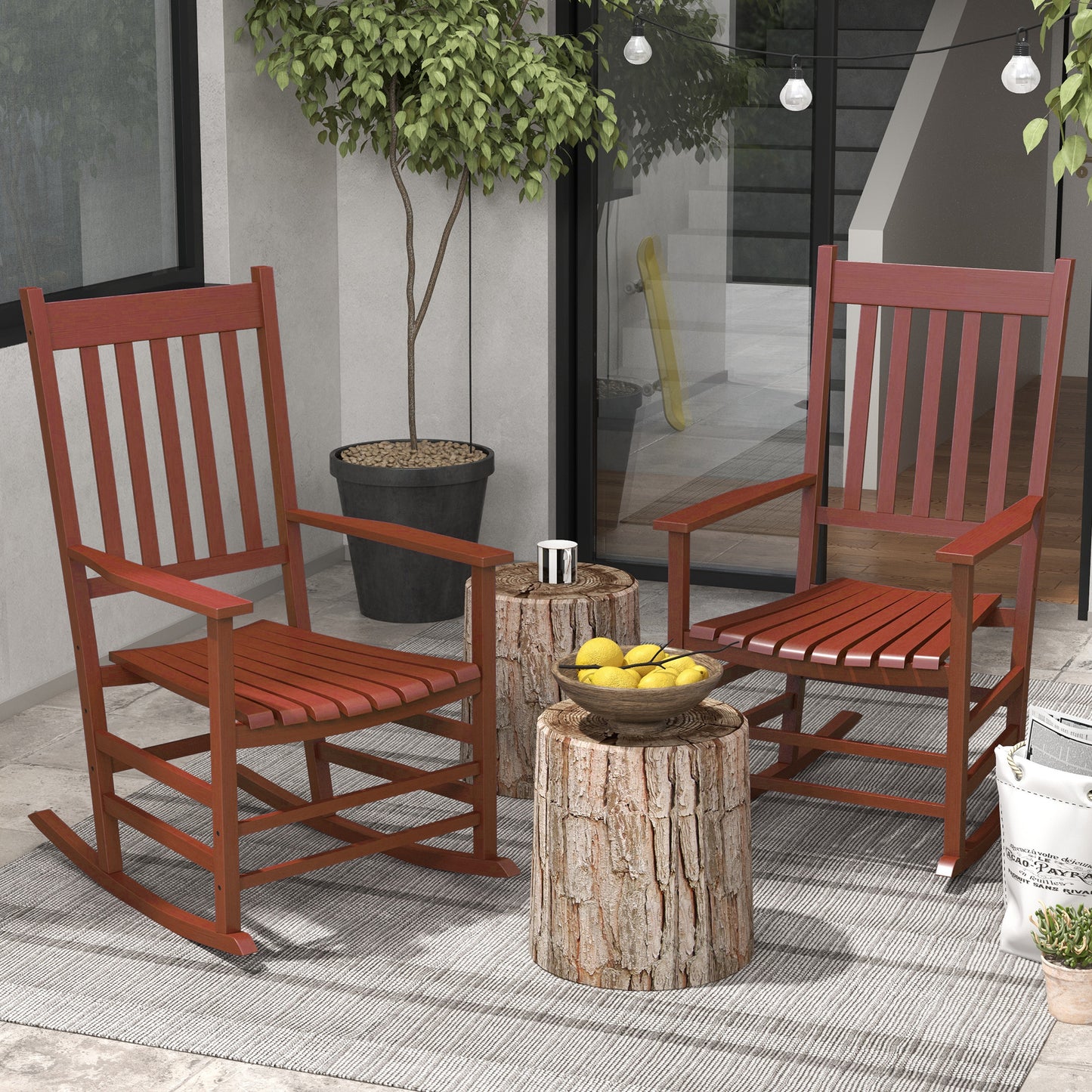 Two classic red wooden rocking chairs on an outdoor patio perfect for a relaxed porch