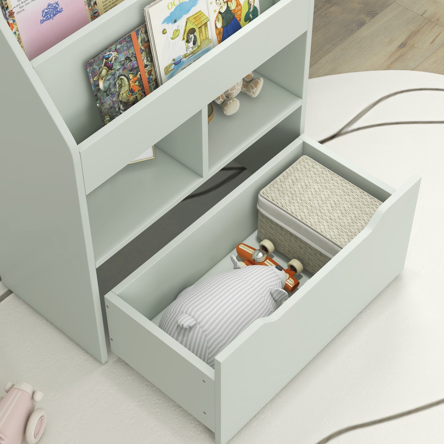 Pale green wooden bookshelf with childrens books and toys neatly stored