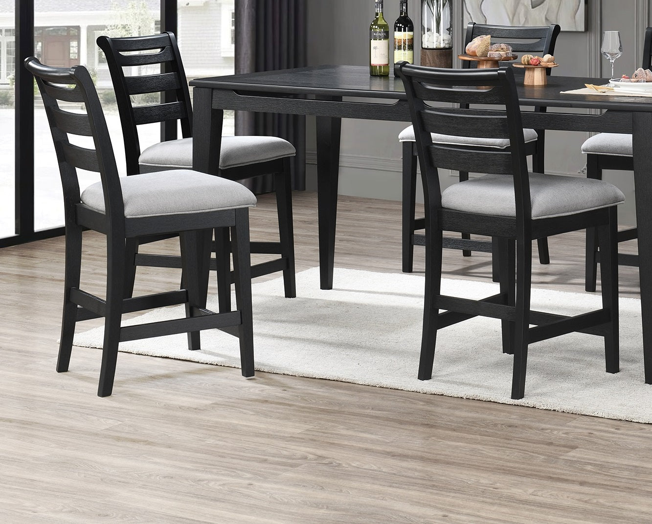 Black wooden bar stool with light grey upholstered seat and horizontal back slats