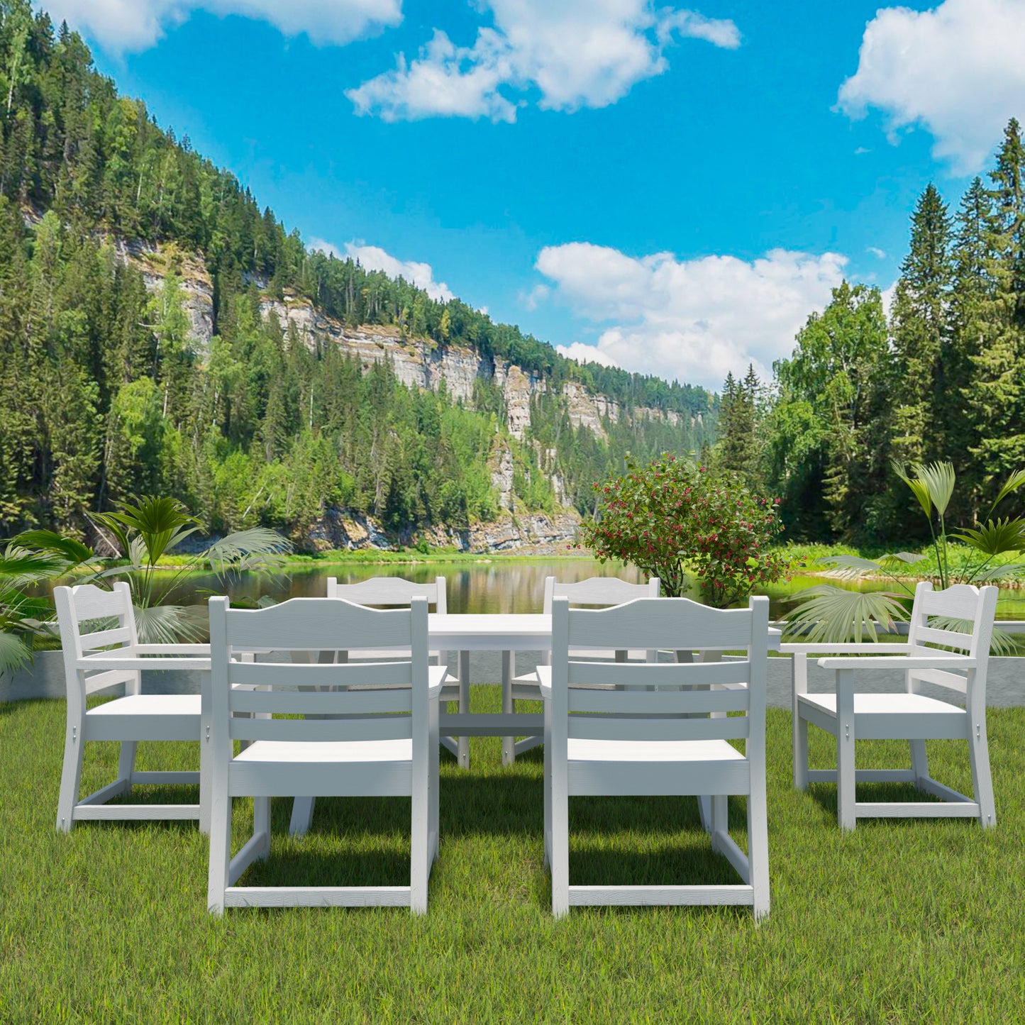White wooden patio dining set with chairs and table on a grassy lawn with lake and mountain backdrop