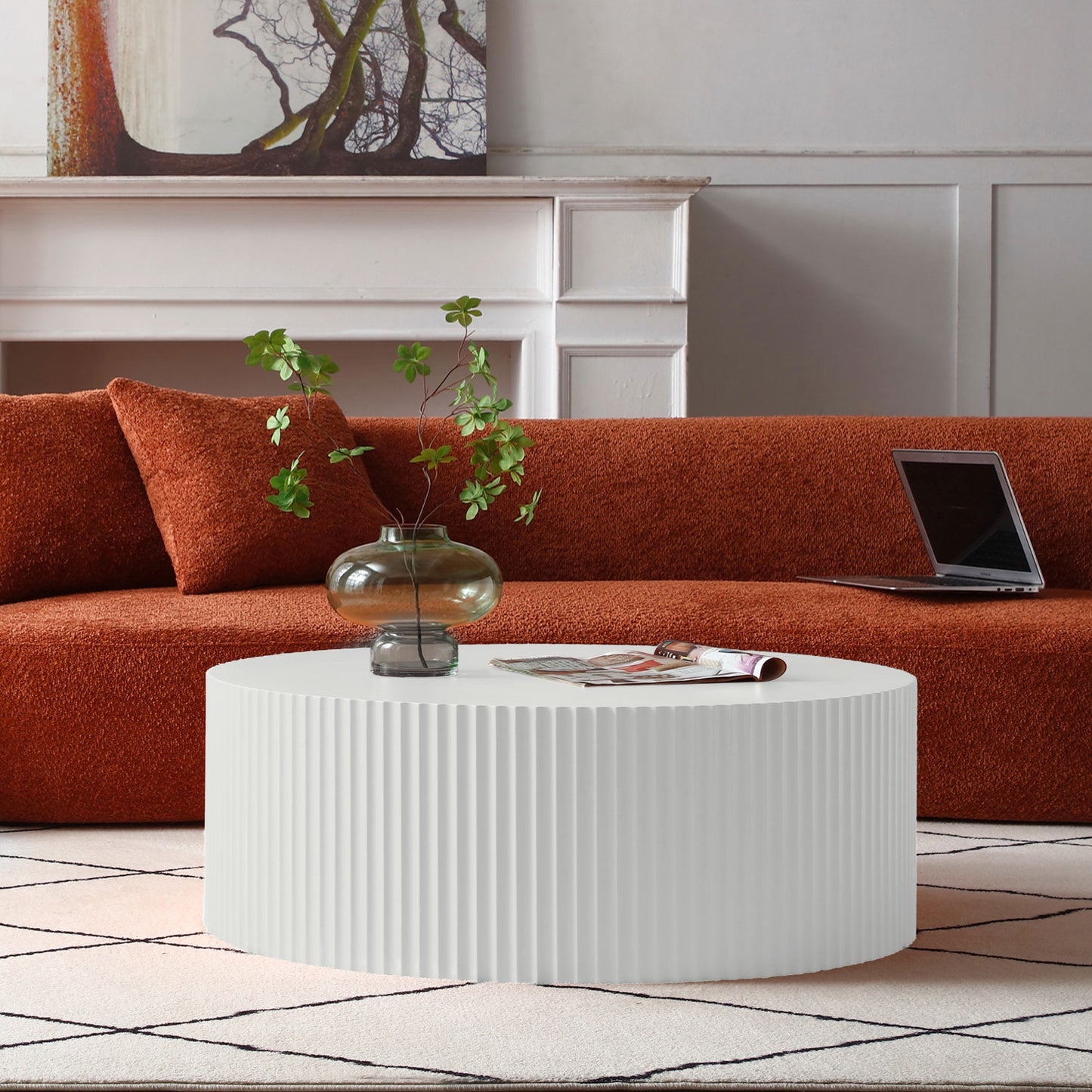 White fluted coffee table with modern minimalist design and plush rust sofa