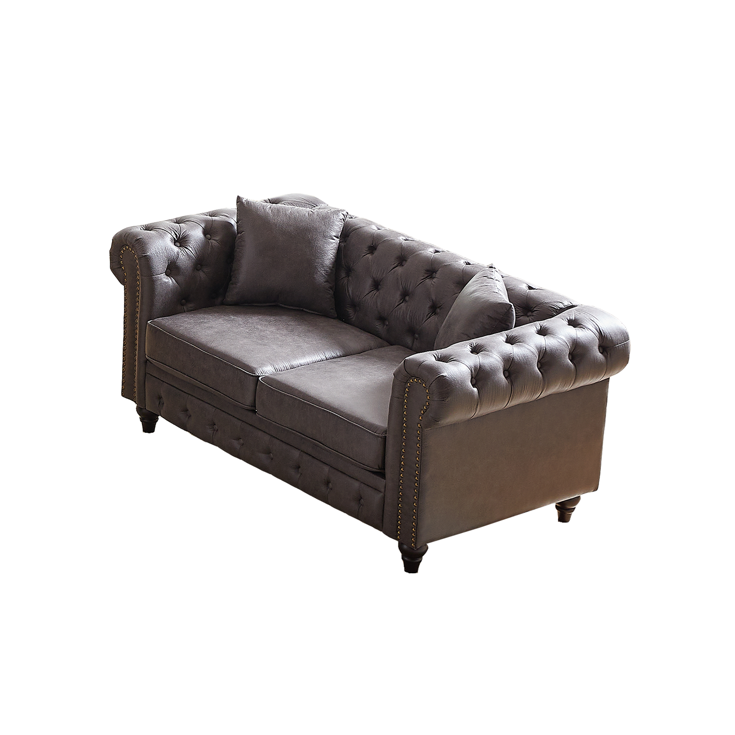 Dark grey leather chesterfield sofa with button tufting brass nailhead trim and plush accent pillow