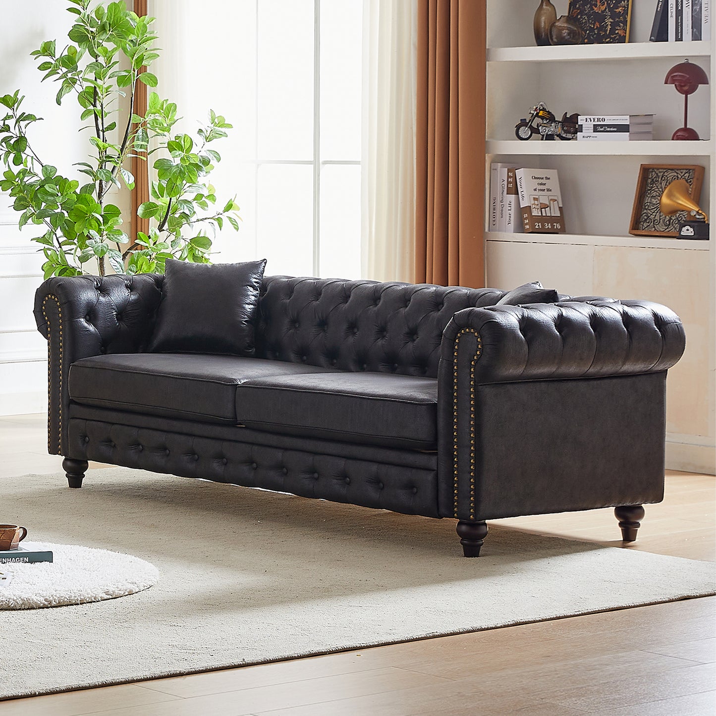 Dark brown tufted faux leather sofa with brass nailhead trim and dark wood legs