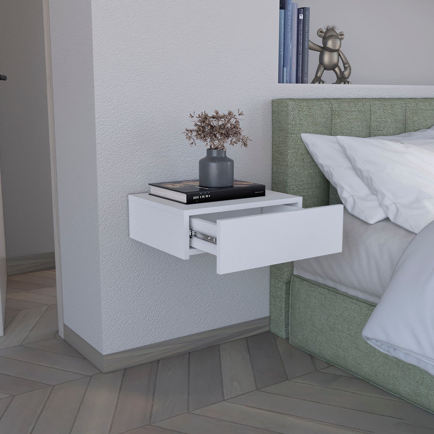 Modern white floating nightstand with open drawer featuring a book and vase decor