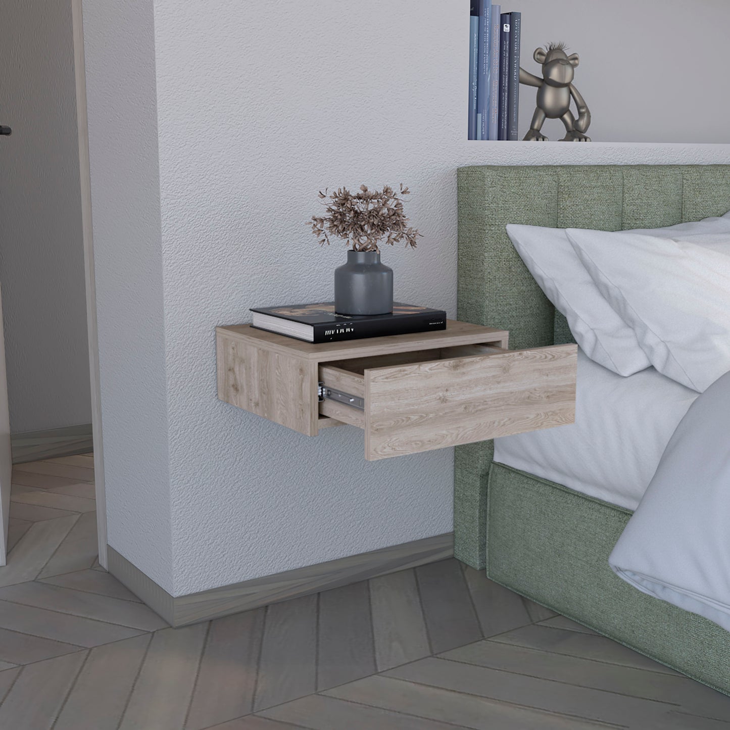 Light oak wood floating nightstand with one open drawer and decorative items on top