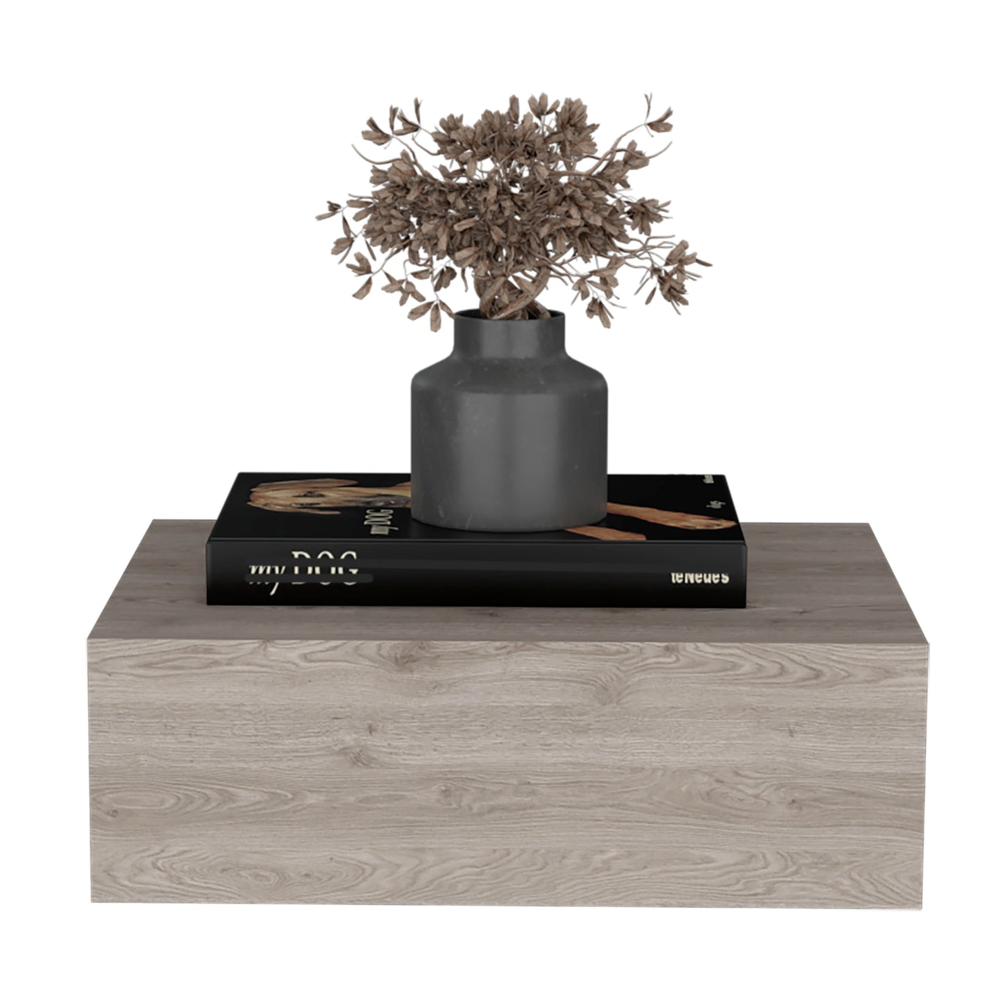 Grey ceramic vase with dried branch decor on black coffee table book