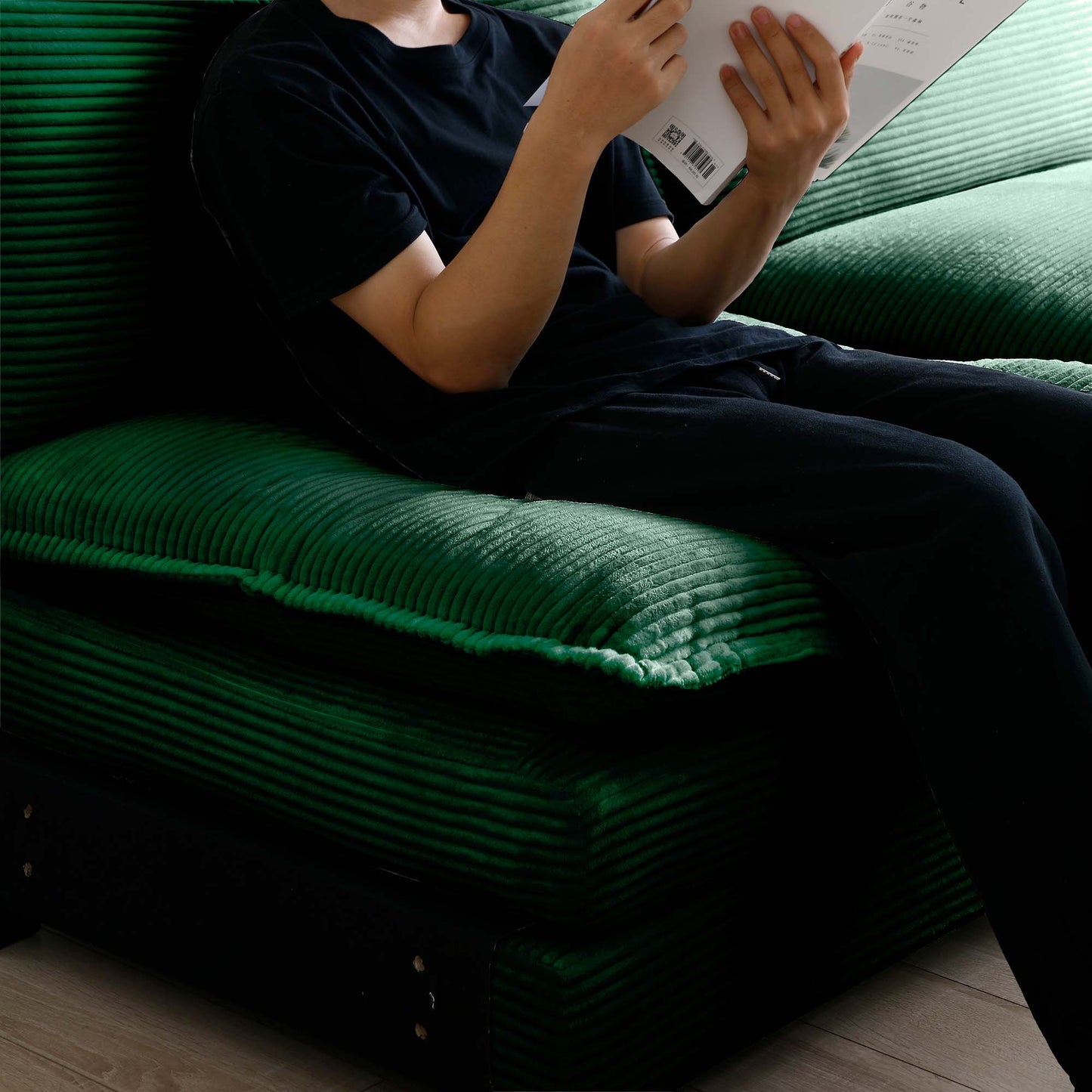Deep green corduroy sofa cushion with plush texture perfect for a cozy living room setup