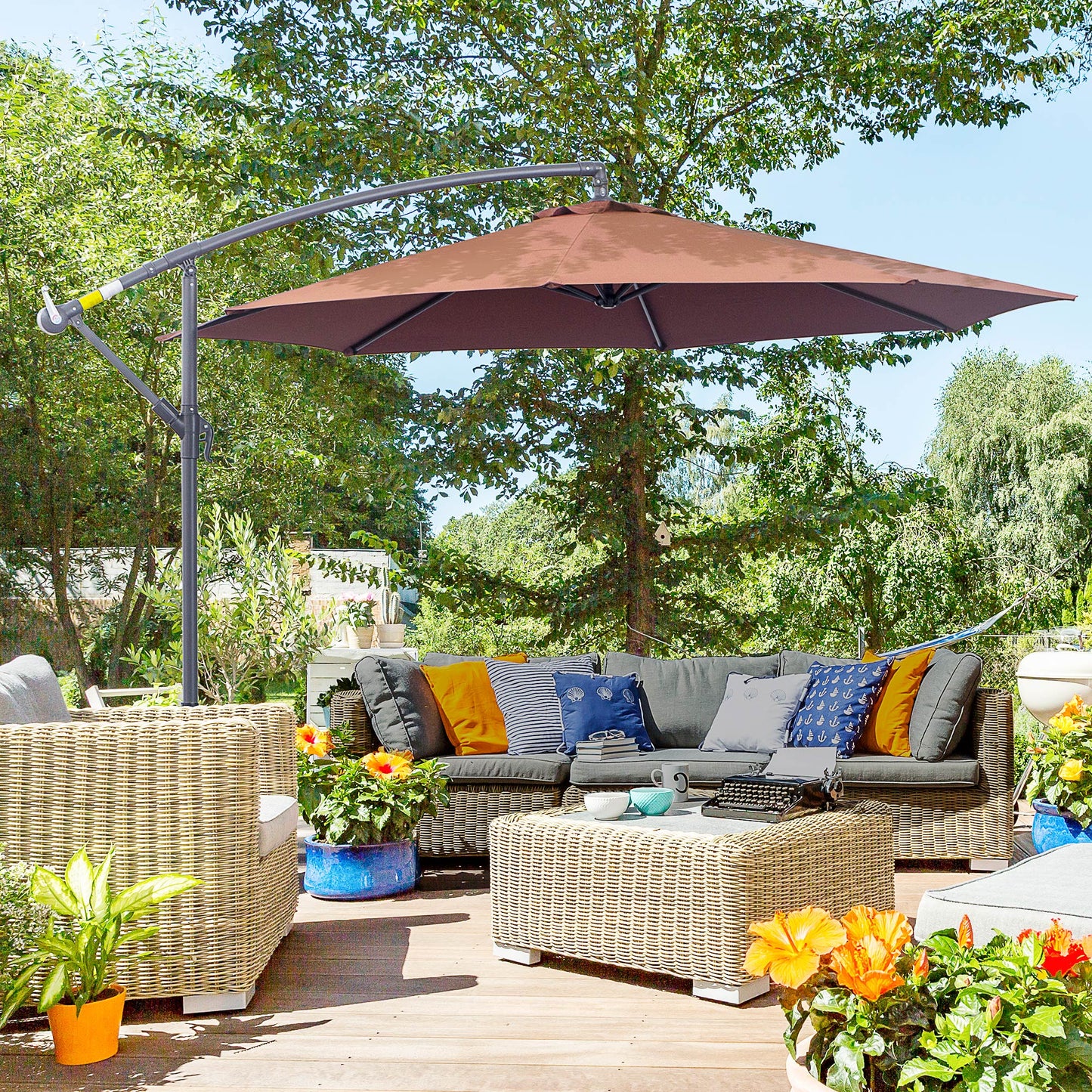 Large brown cantilever umbrella providing shade over a wicker patio furniture set and coffee table