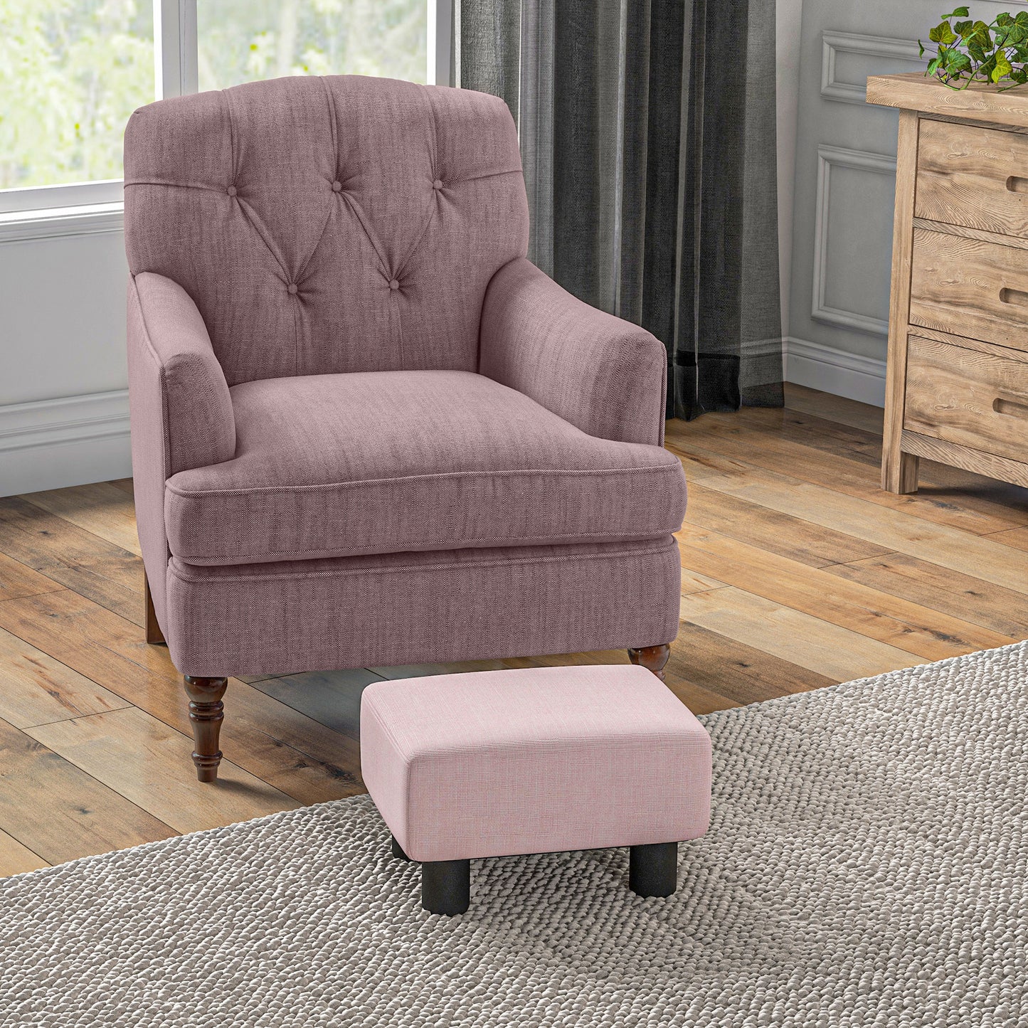 Tufted rose gold armchair with a matching ottoman on a textured rug