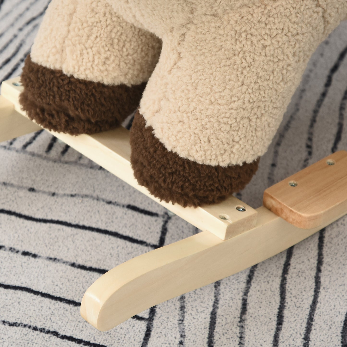 Plush beige rocking horse legs with brown hooves on a wooden base