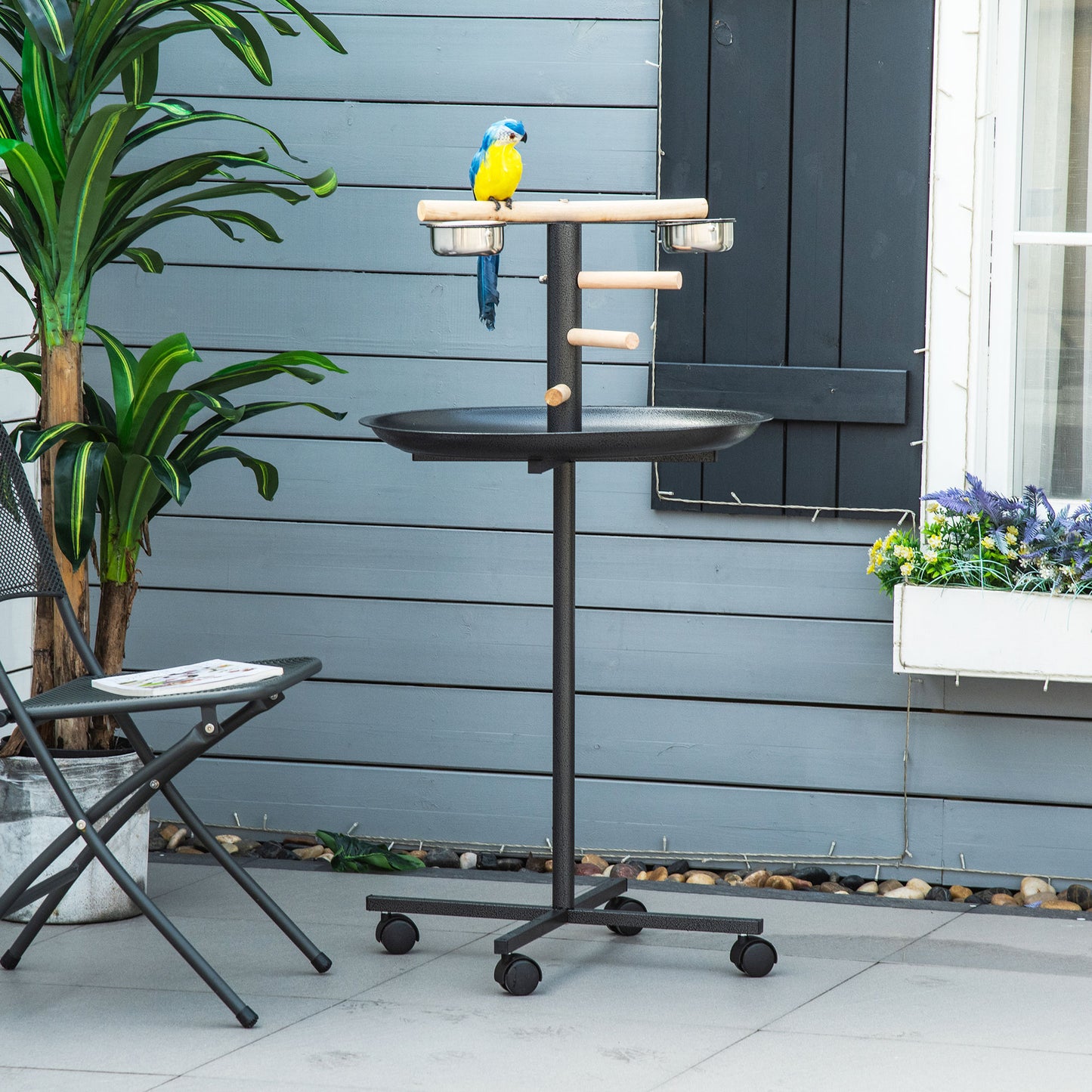 Black metal bird stand with perch and feeders for parrots and large birds