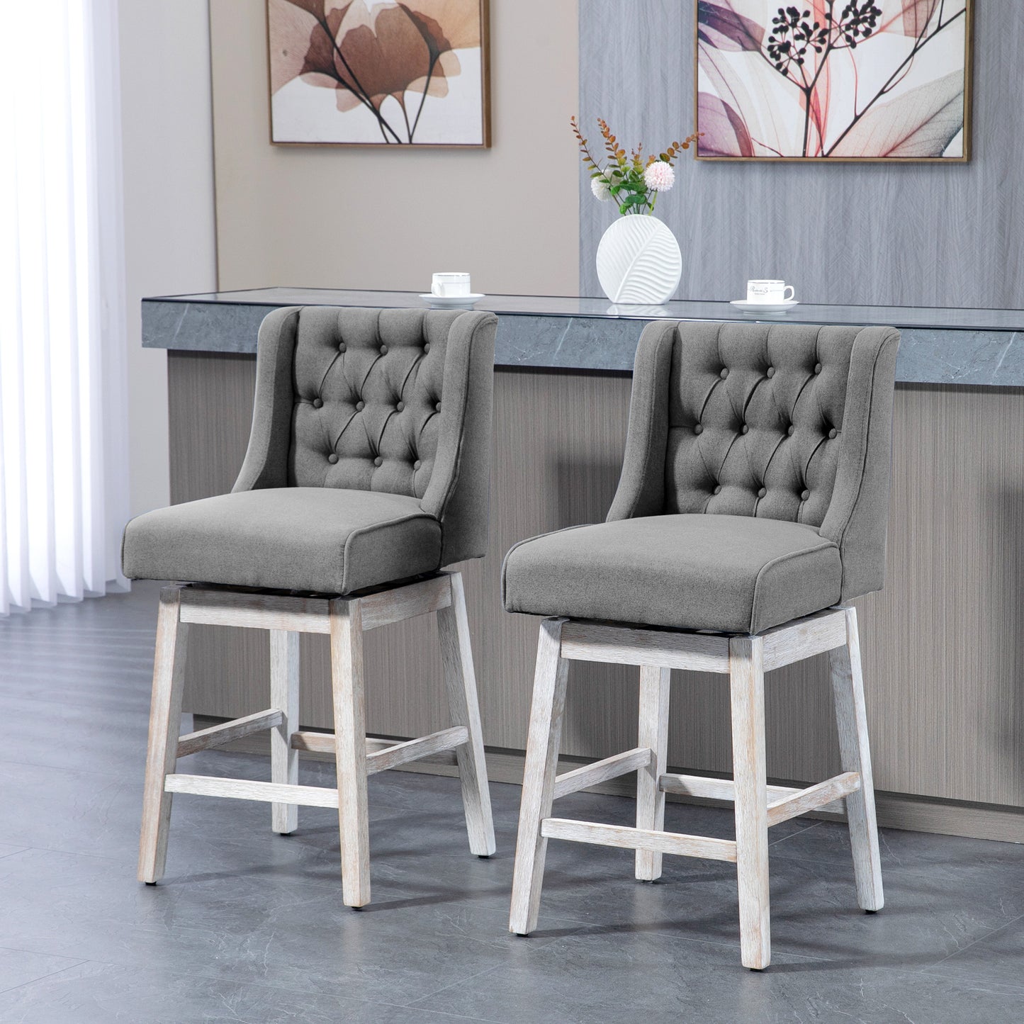 Tufted gray fabric swivel bar stool with distressed white wood legs and channel stitching detail