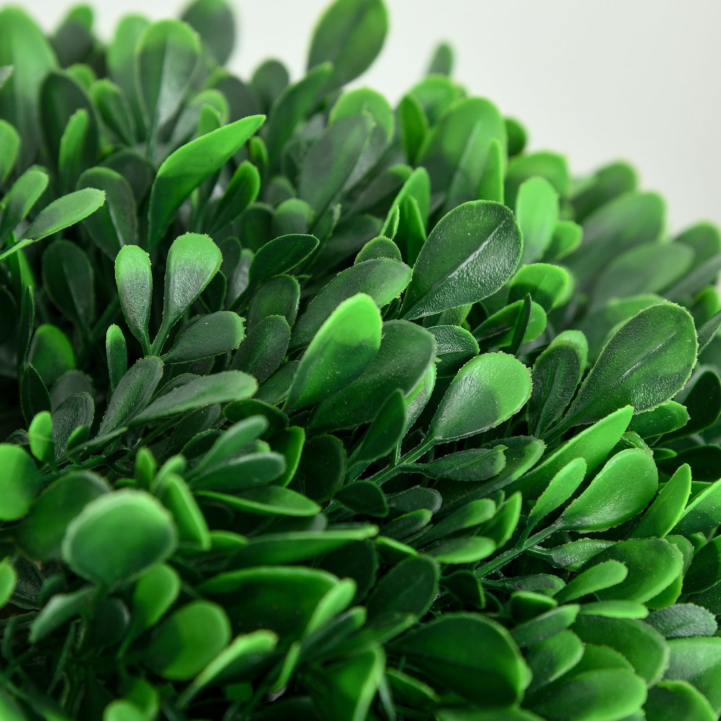 Closeup of lush green faux boxwood leaves ideal for artificial landscaping