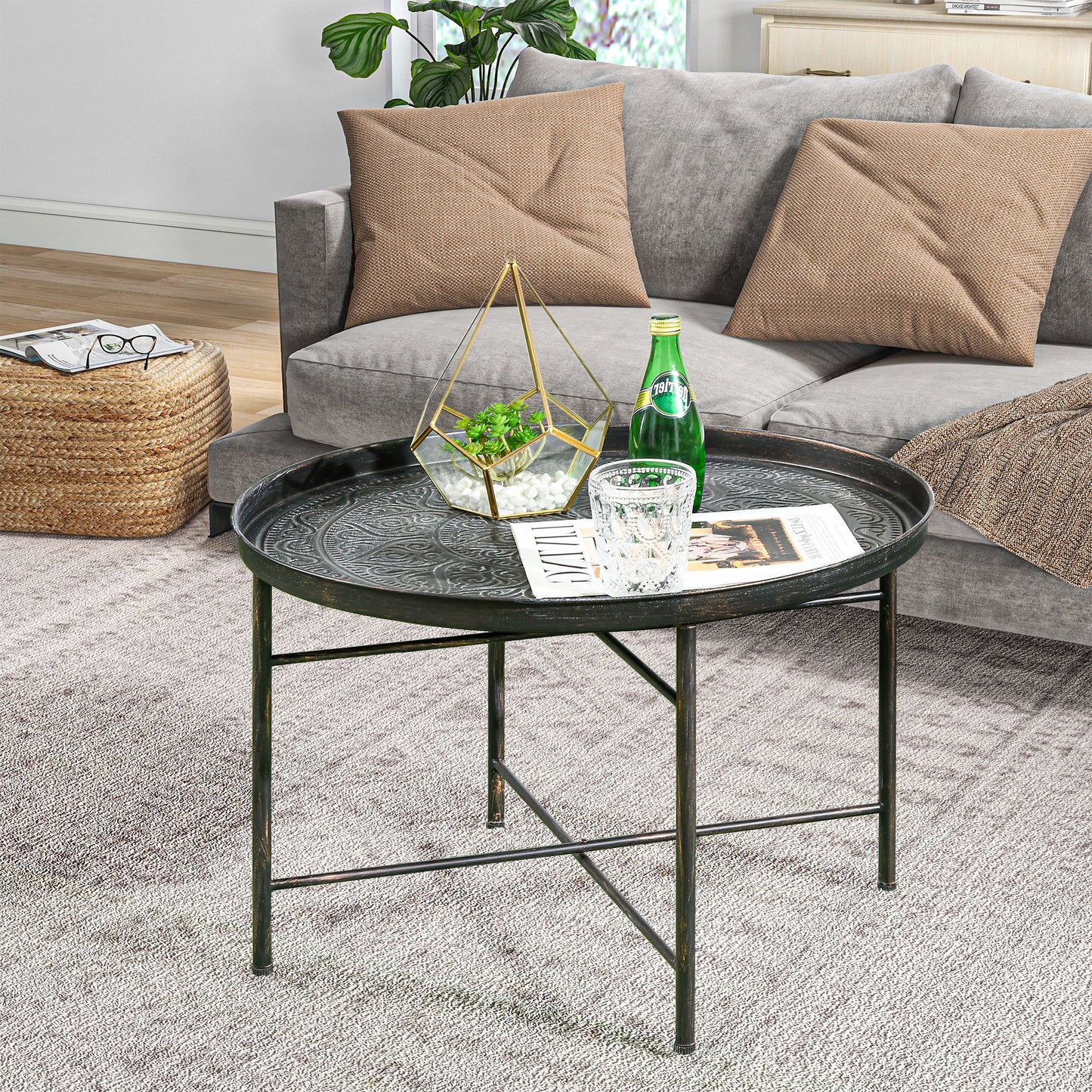 Round antique black metal coffee table with embossed pattern for living room accent