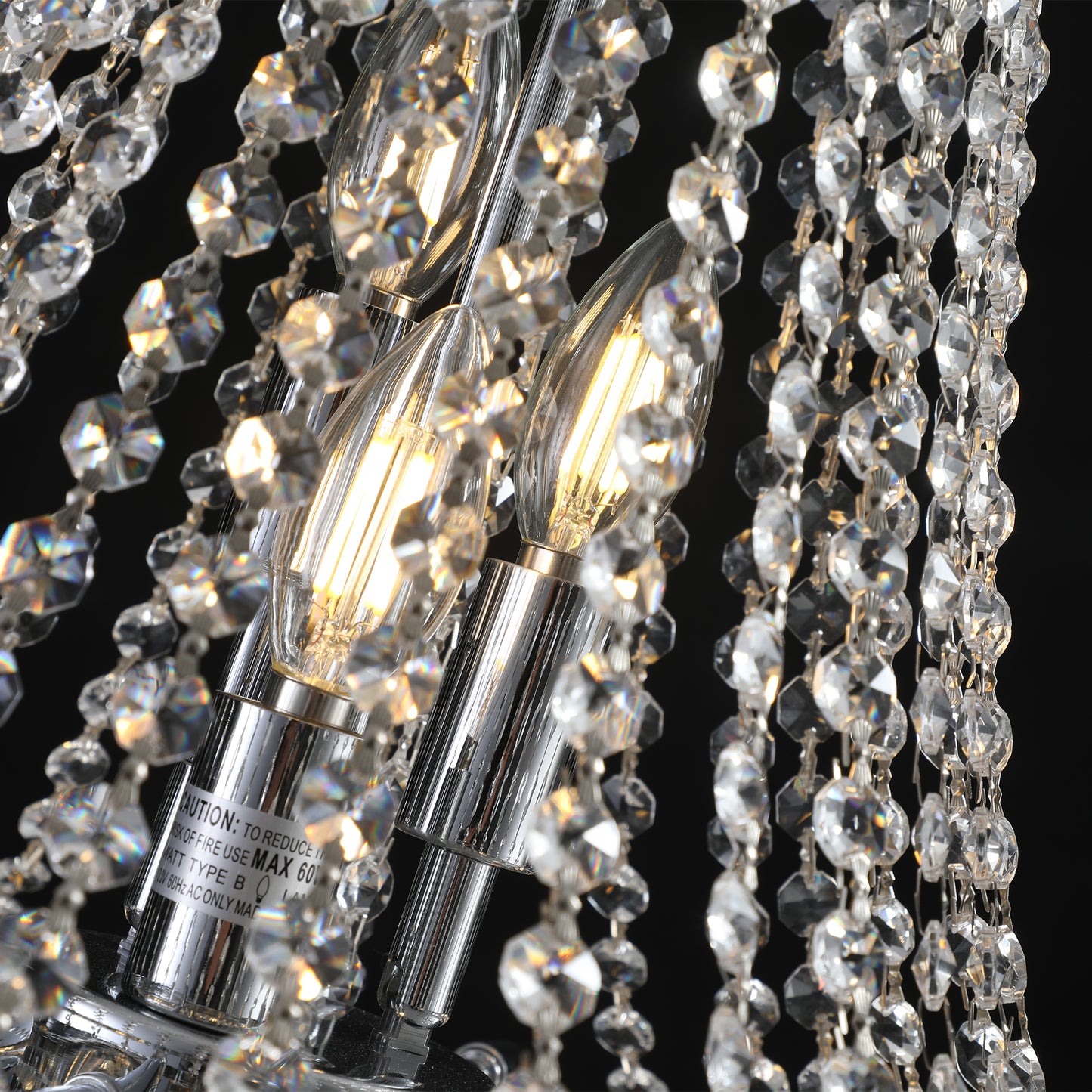 Closeup of a sparkling crystal chandelier with illuminated bulbs and chrome accents