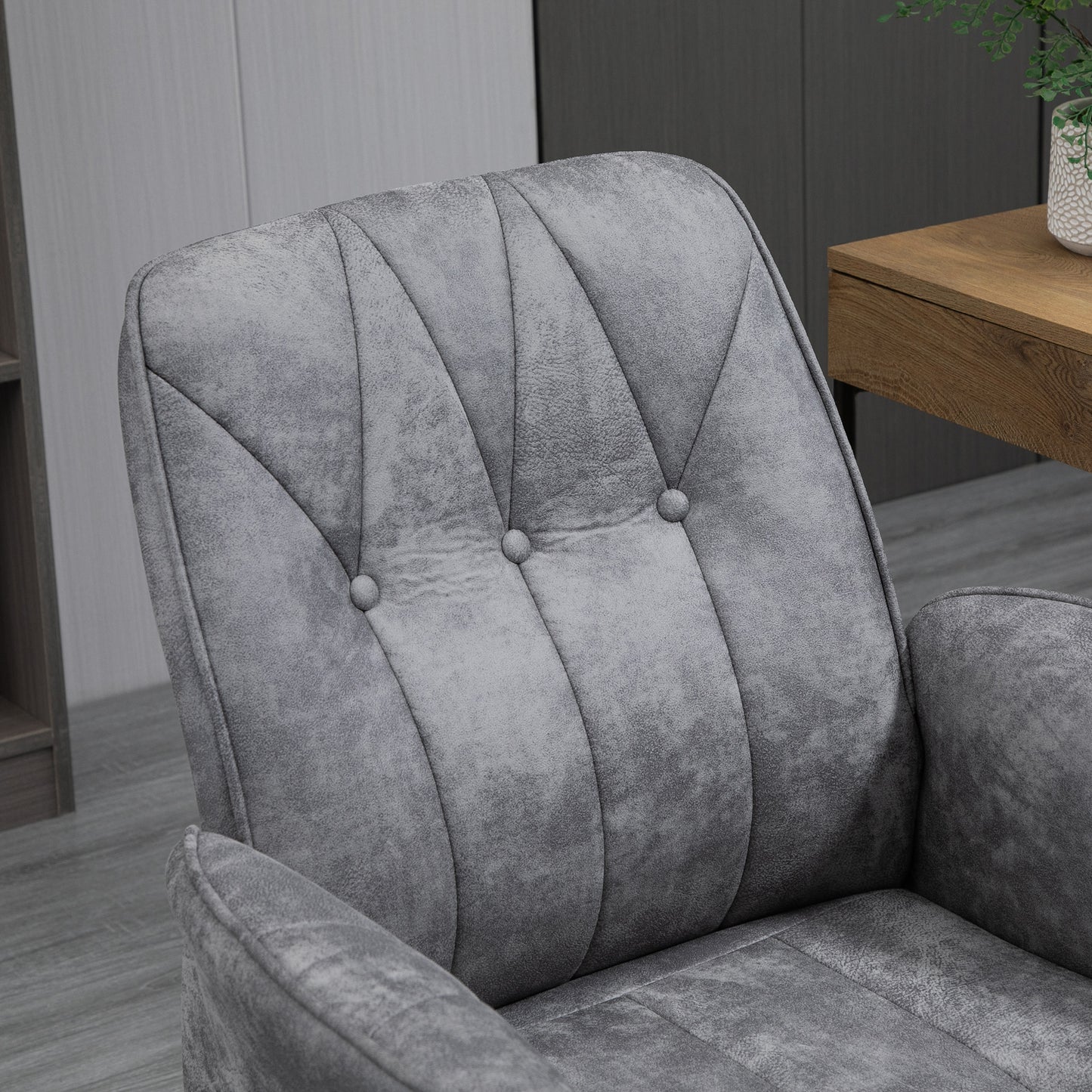 Closeup of a tufted grey velvet armchair accentuating its plush texture and elegant design
