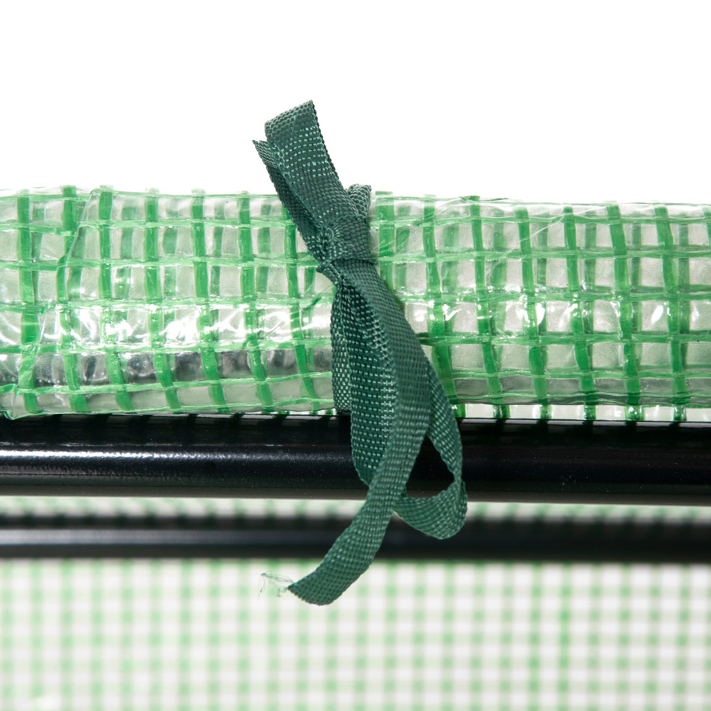 Green reinforced greenhouse film rolled and secured with a dark green fabric tie