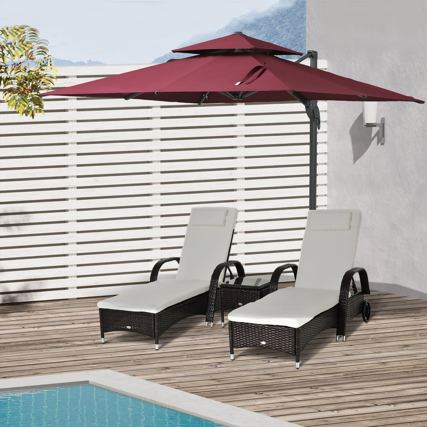 Burgundy patio cantilever umbrella providing shade for two whitecushioned wicker chaise lounge chairs