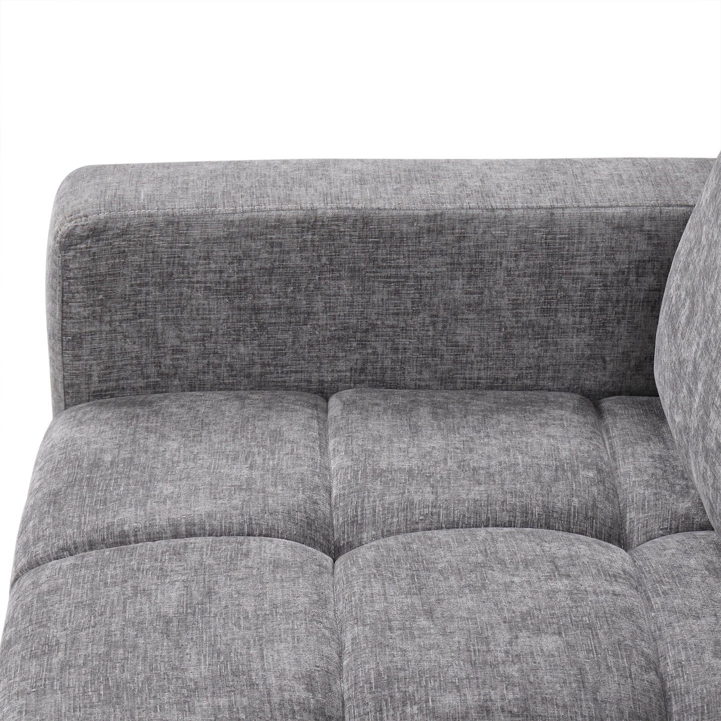 Closeup of a textured grey fabric sofa armrest and tufted seat cushions