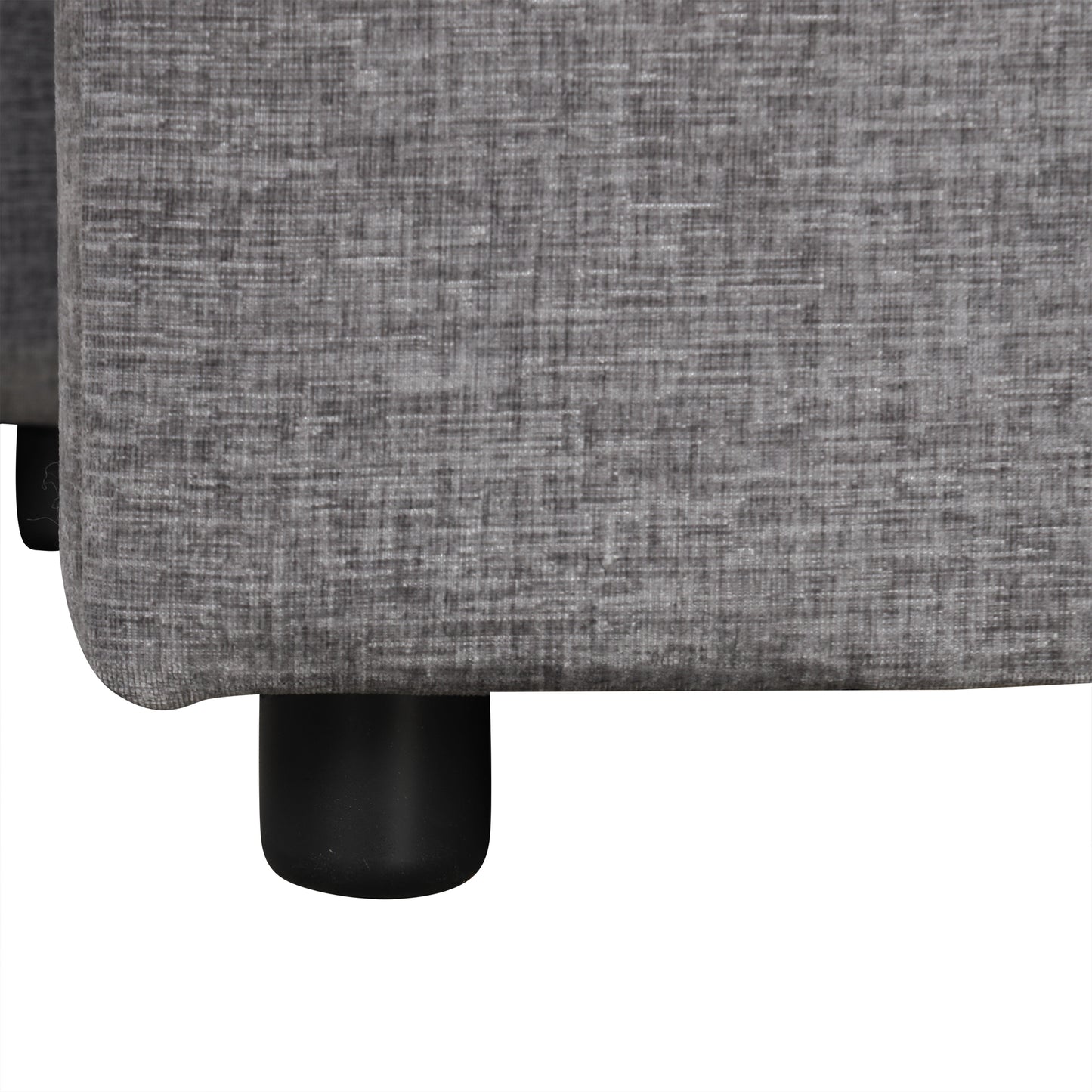Closeup of textured grey fabric sofa upholstery with black cylindrical legs