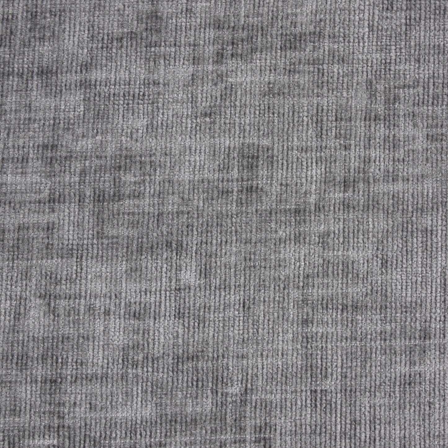 Closeup of textured gray velvet fabric with subtle vertical ribbing for upholstery