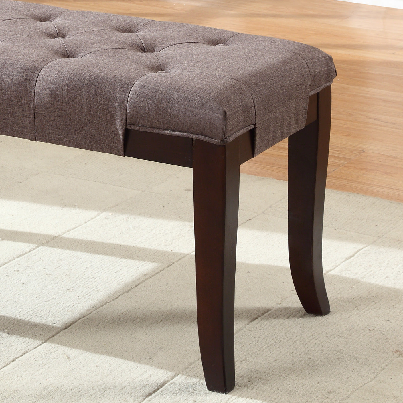 Tufted charcoal fabric bench with dark wood legs ideal for entryway seating