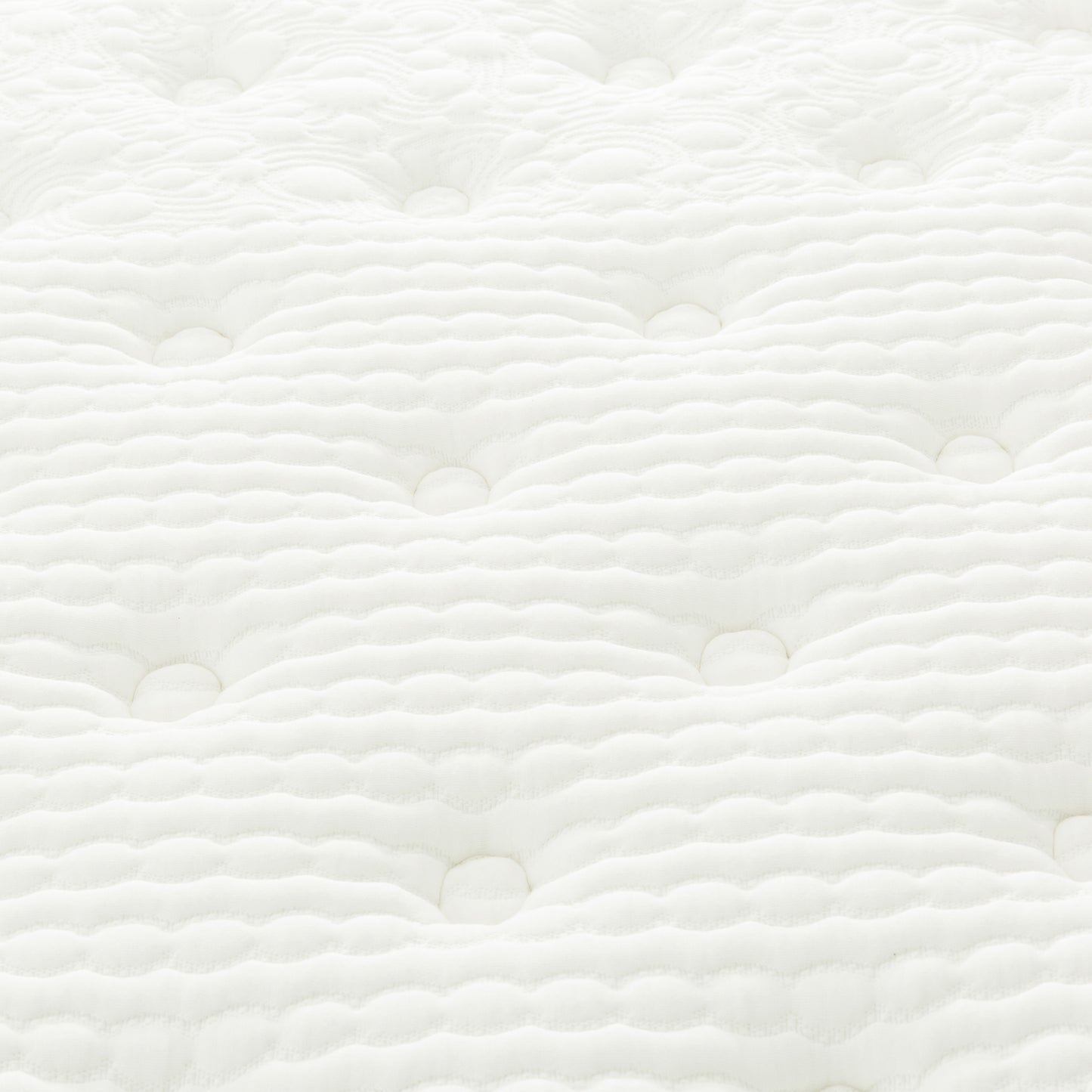 Close up of a quilted white mattress fabric with wavelike tufting