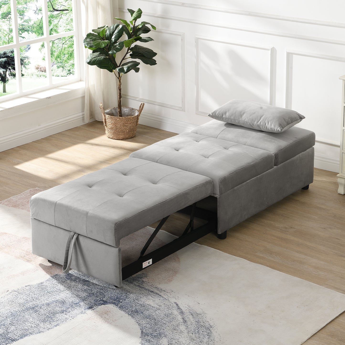 Grey upholstered sleeper chair with extended ottoman and tufted cushions