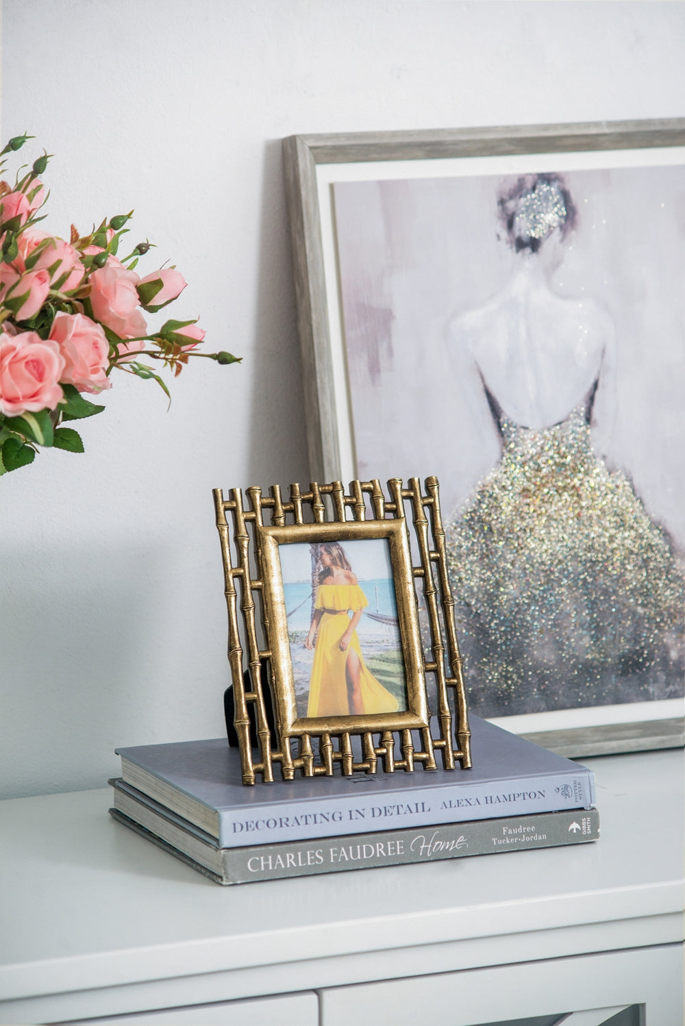 Golden bamboo photo frame holding image of woman in yellow dress