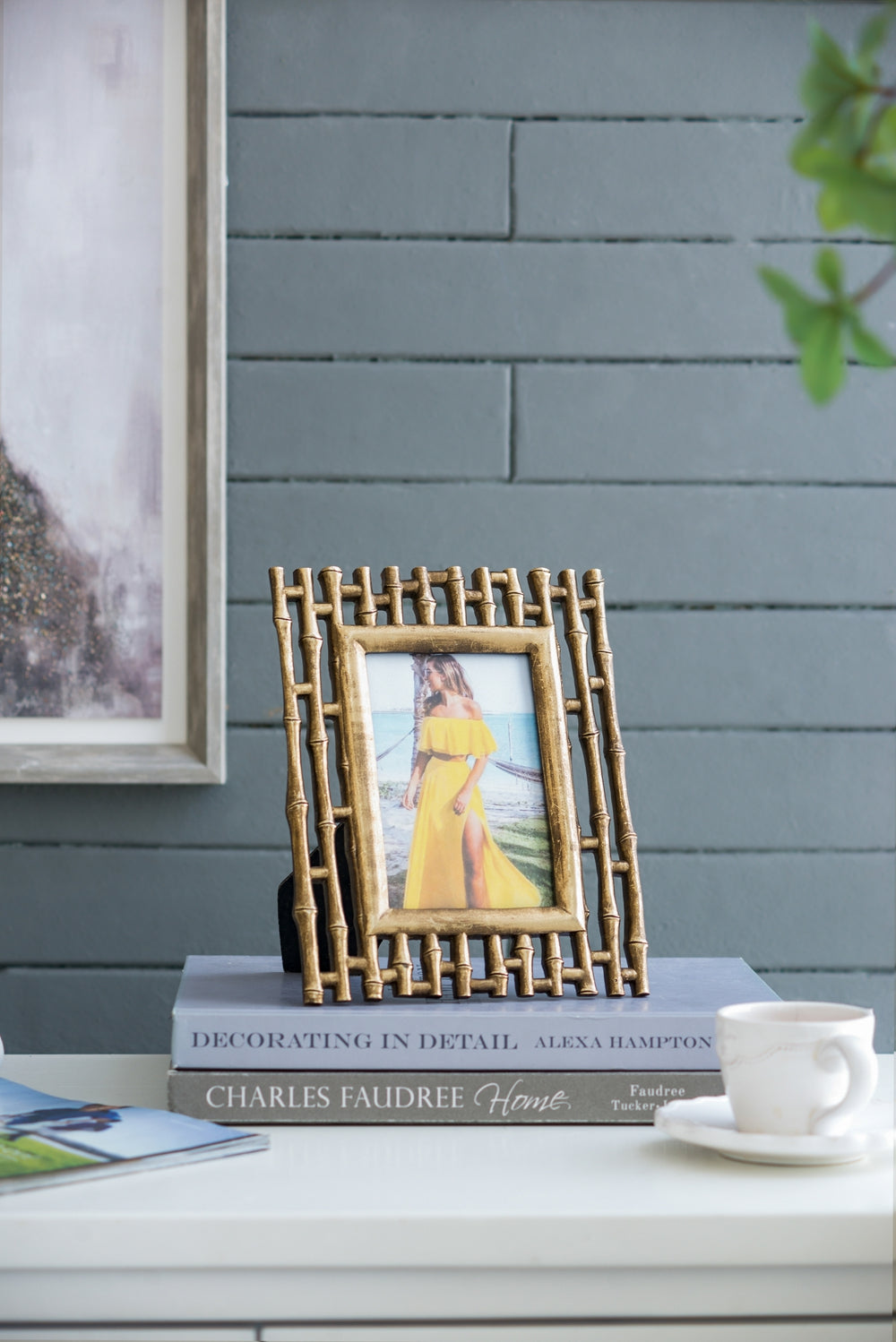 Gold bamboo picture frame holding a woman in a yellow dress on a beach