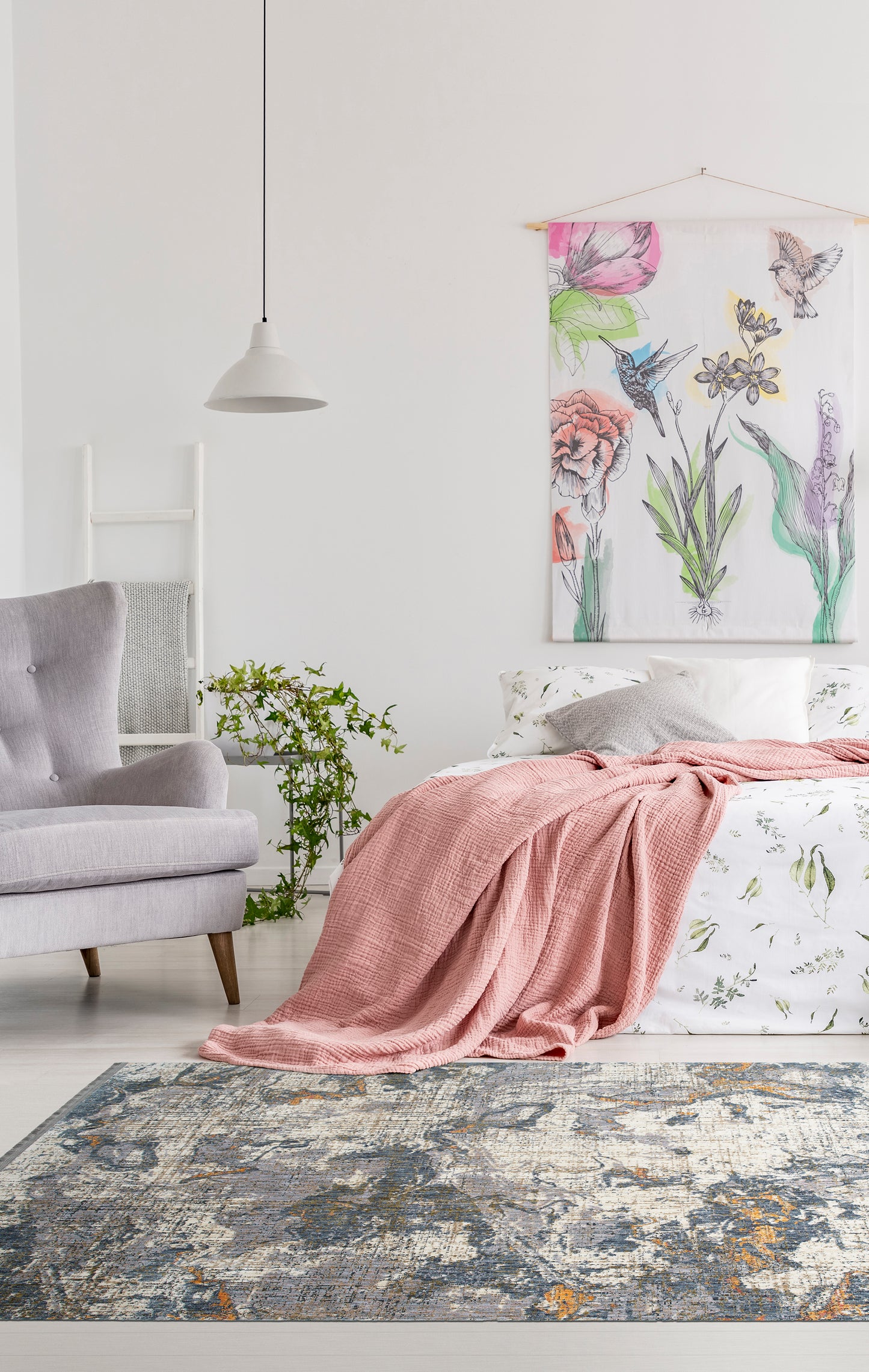Dusty rose textured throw blanket draped over a white floral duvet cover