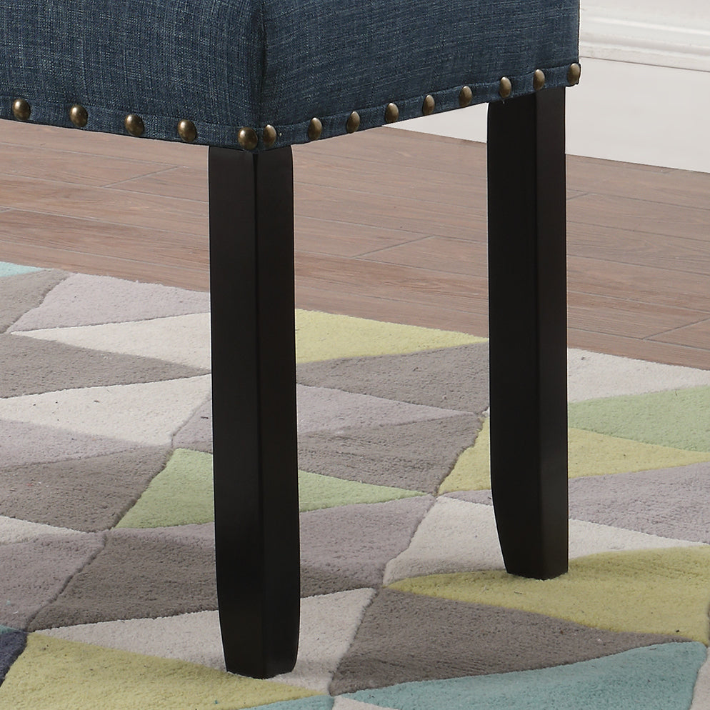 Dark blue upholstered bench with brass nailhead trim