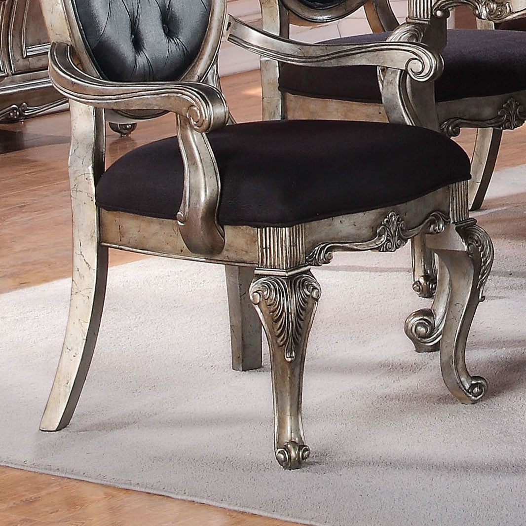 Ornate silverfinished dining chair with black upholstered seat and tufted backrest