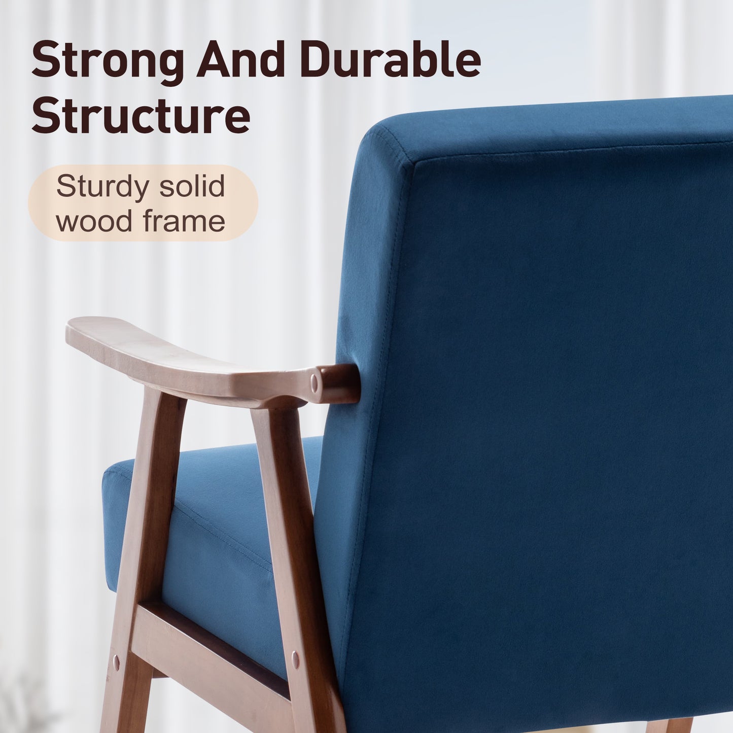 Closeup of a navy blue upholstered armchair with a solid wood frame