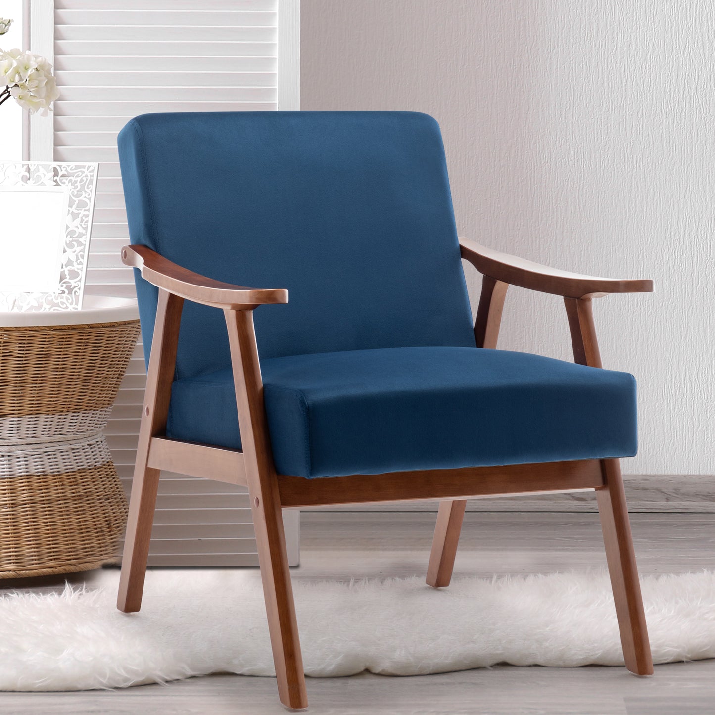 Deep blue velvet armchair with light wood legs and arms midcentury modern accent chair