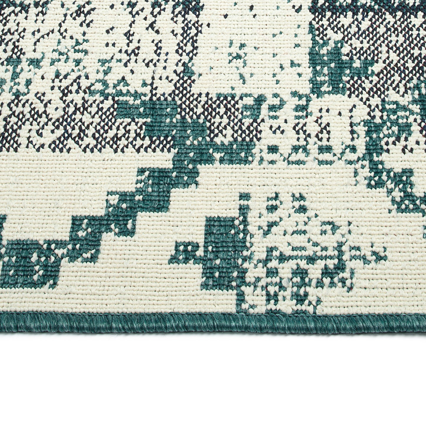 Closeup of a cream rug with an abstract teal and black geometric pattern