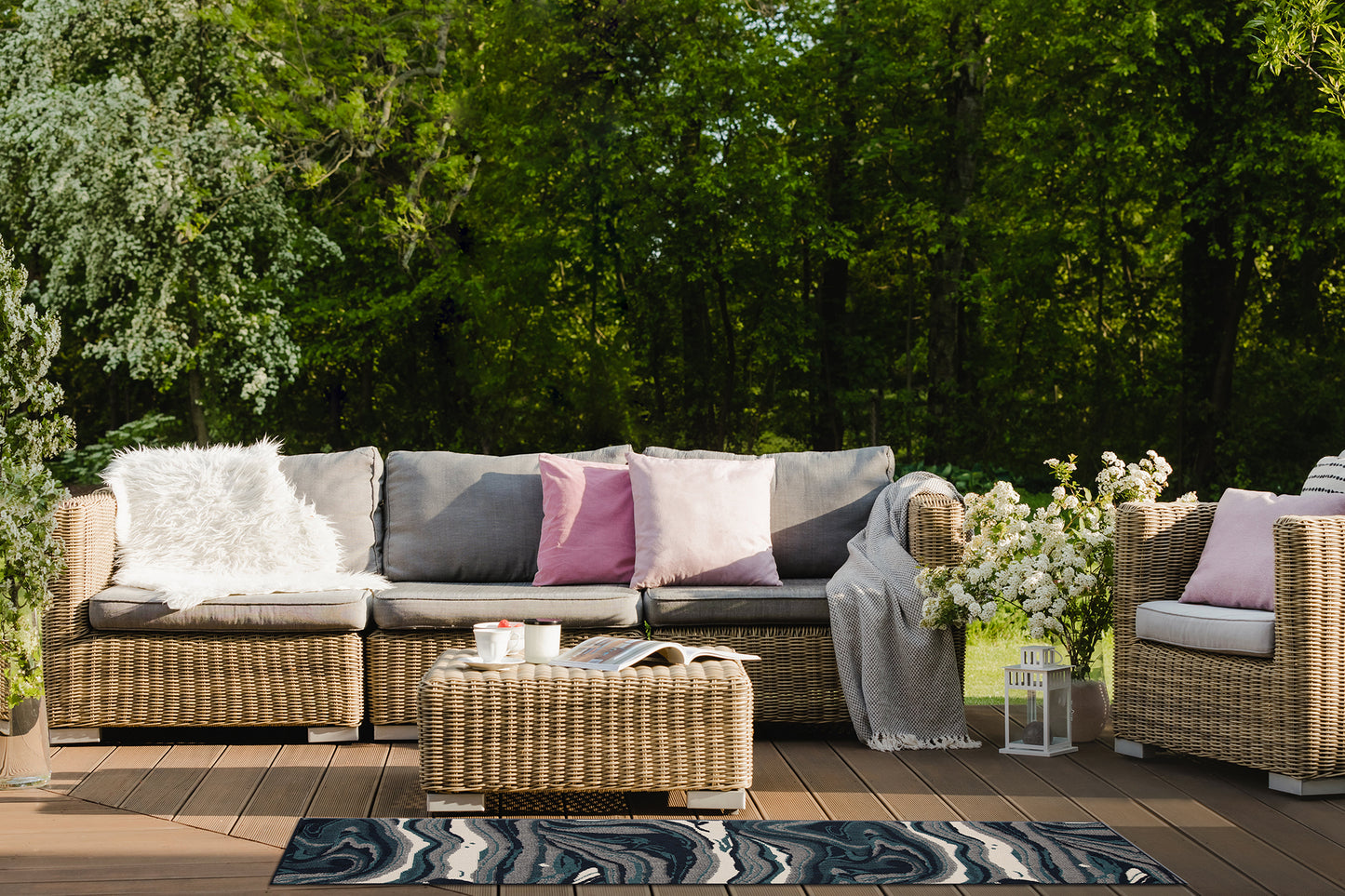 Wicker outdoor sectional sofa with gray cushions and plush white accent pillow perfect for patio relaxation
