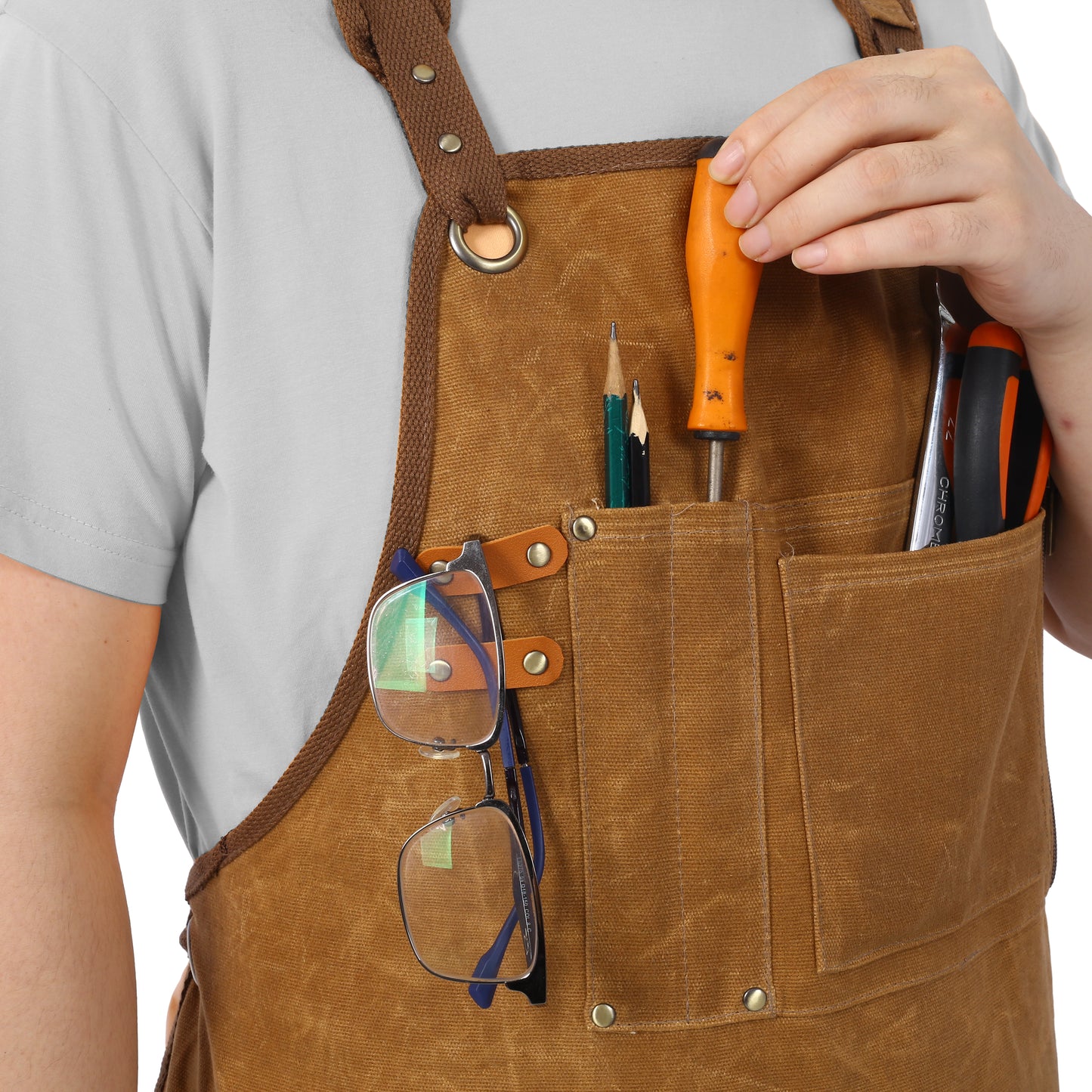 Durable brown canvas work apron with tool pockets holding pencils and a screwdriver