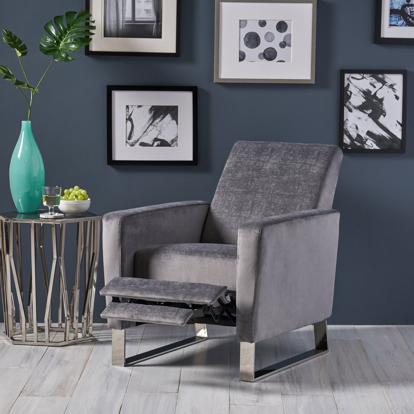 Grey velvet recliner chair with chrome legs and footrest deployed
