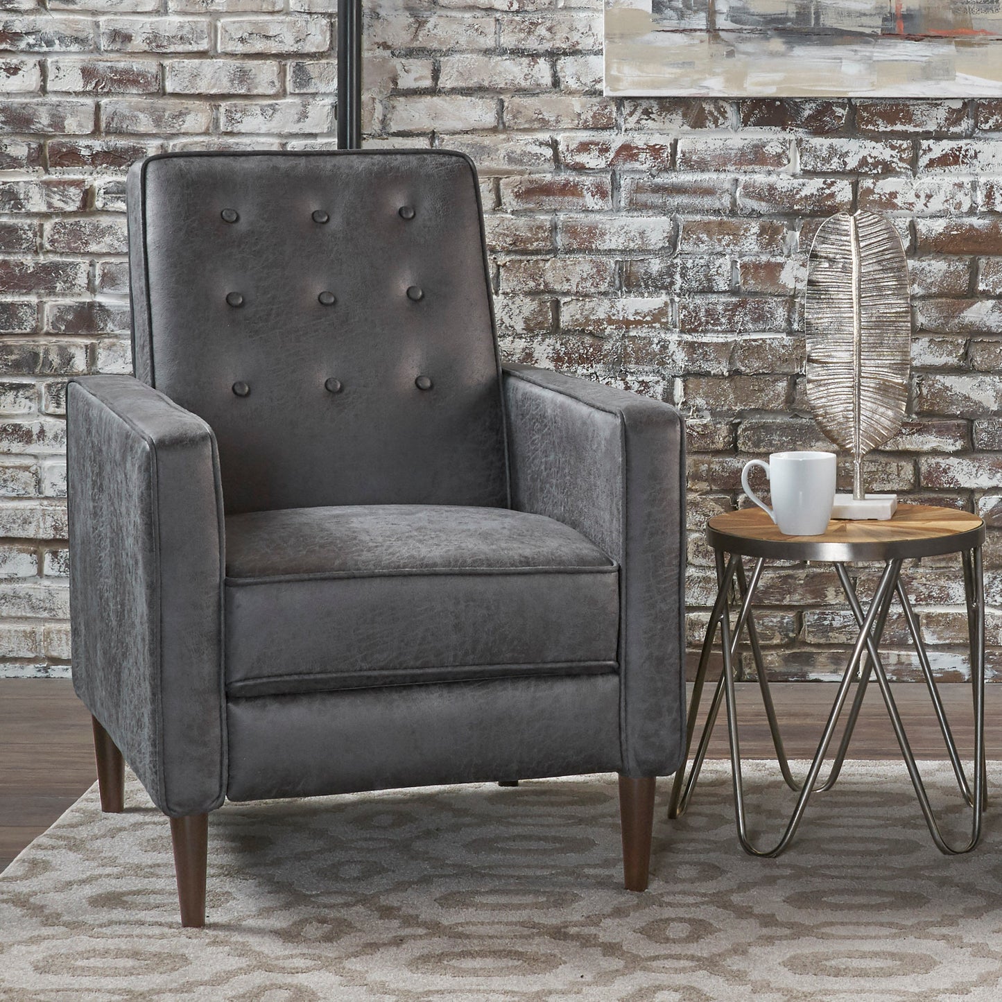 Dark gray tufted accent chair with button details and tapered wooden legs