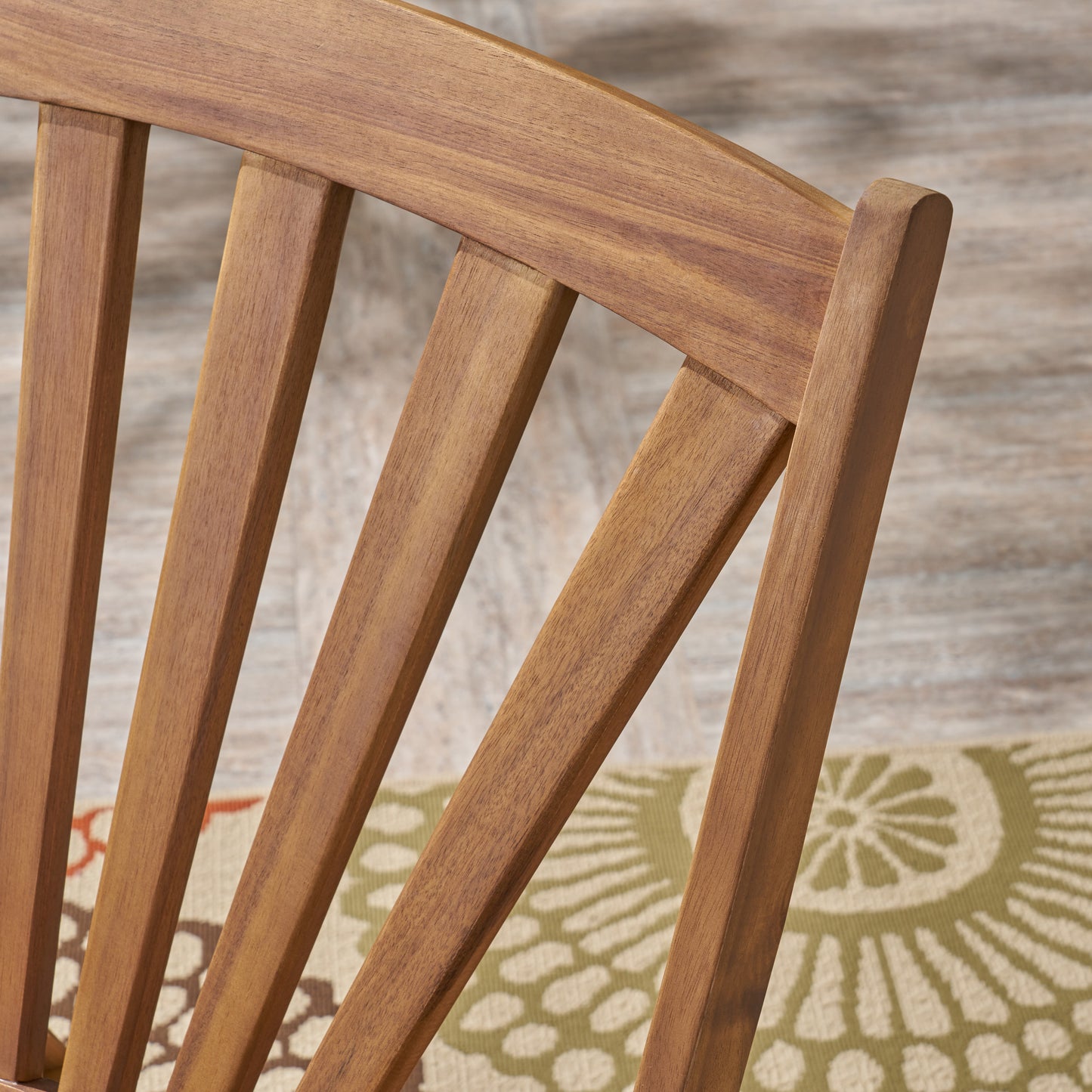 Closeup of natural wood chair back with slatted design