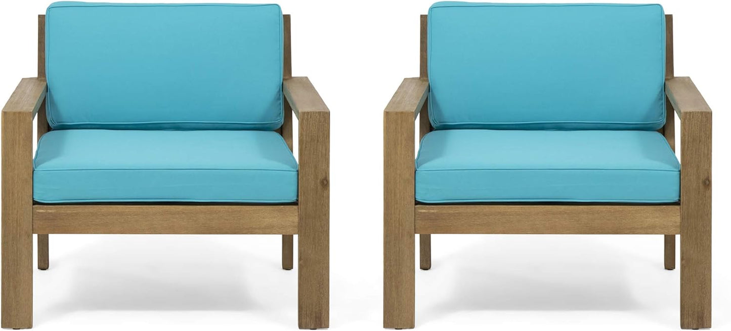 Two modern outdoor chairs with teal cushions and wooden frames