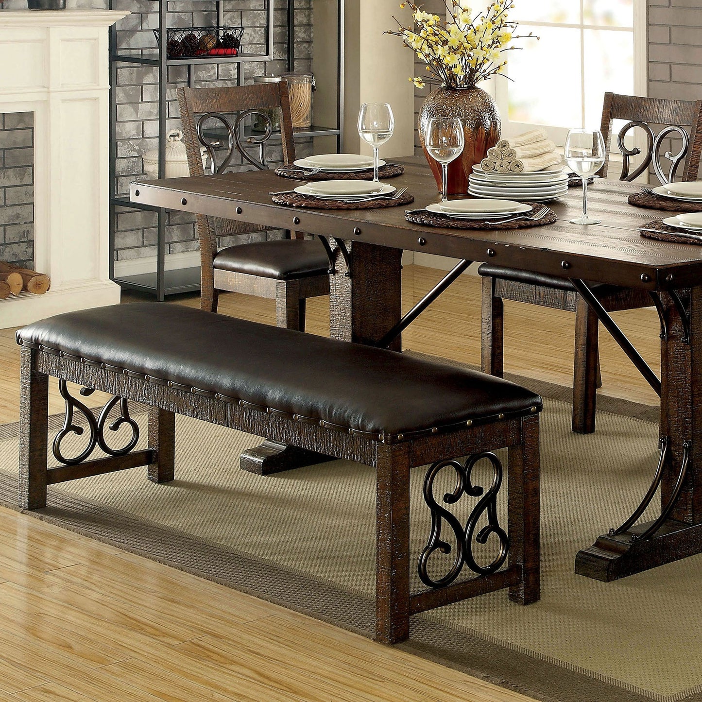 Dark brown leather upholstered dining bench with ornate metal scrollwork and distressed wood frame