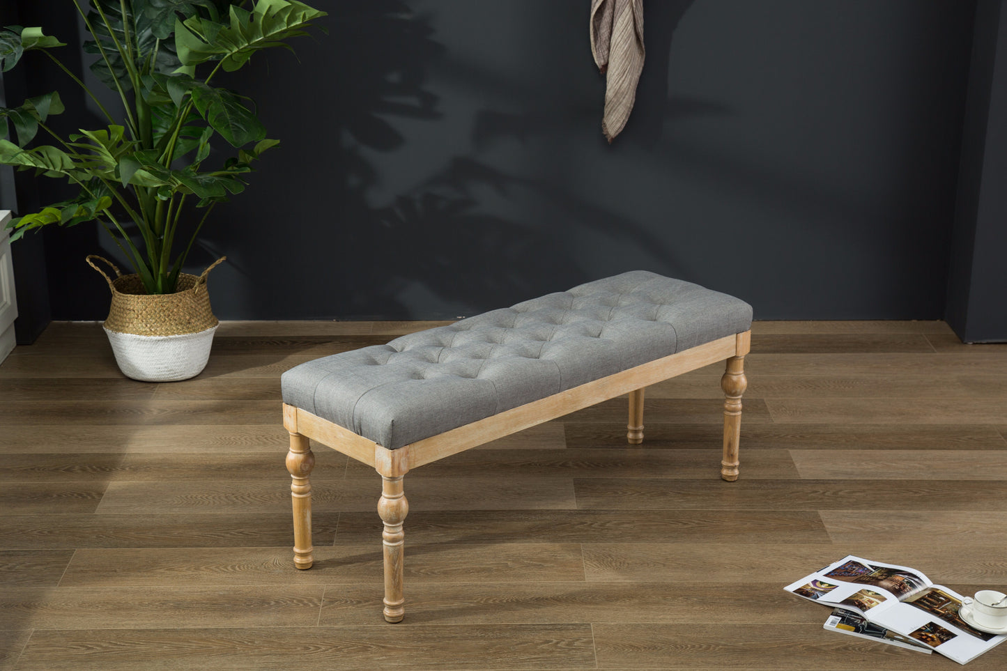Tufted grey linen bench with carved natural wood legs perfect as a decorative accent bench