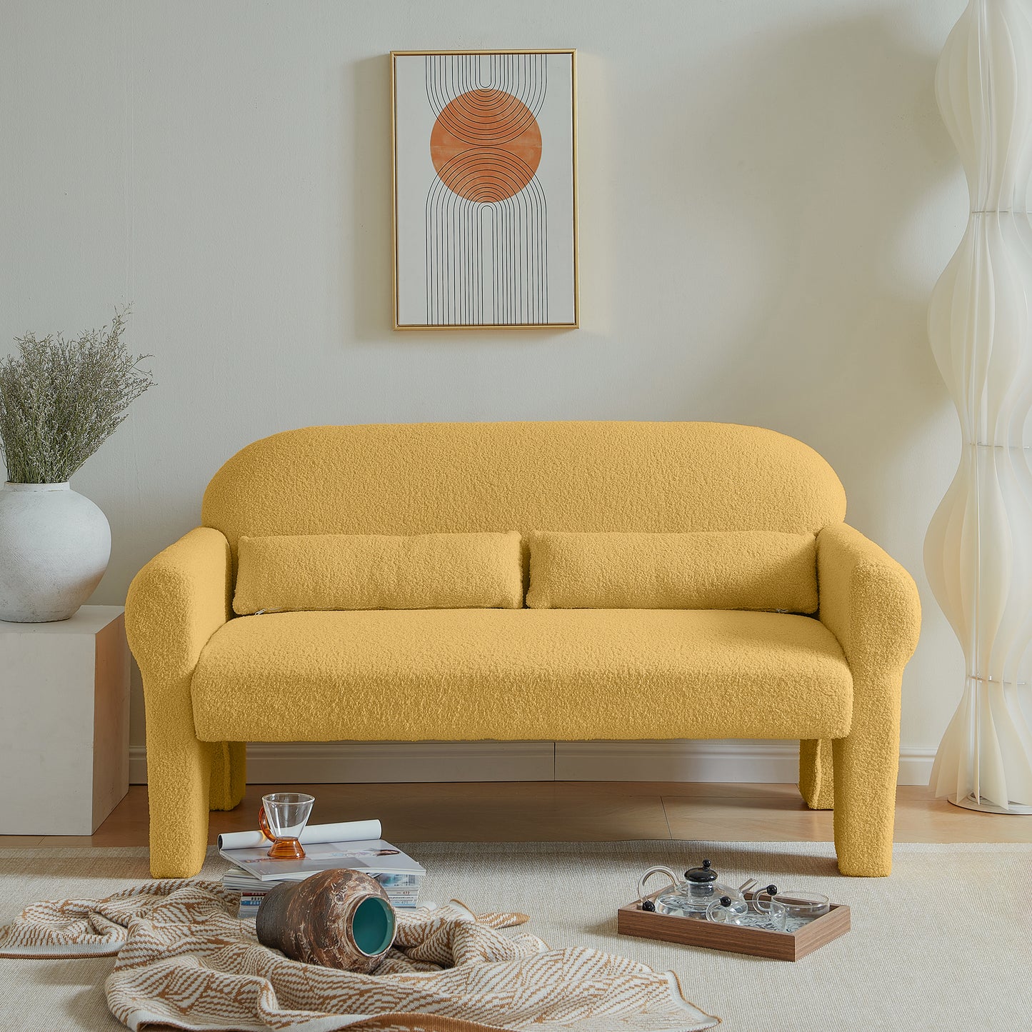 Yellow boucle fabric sofa with rounded arms and two accent pillows