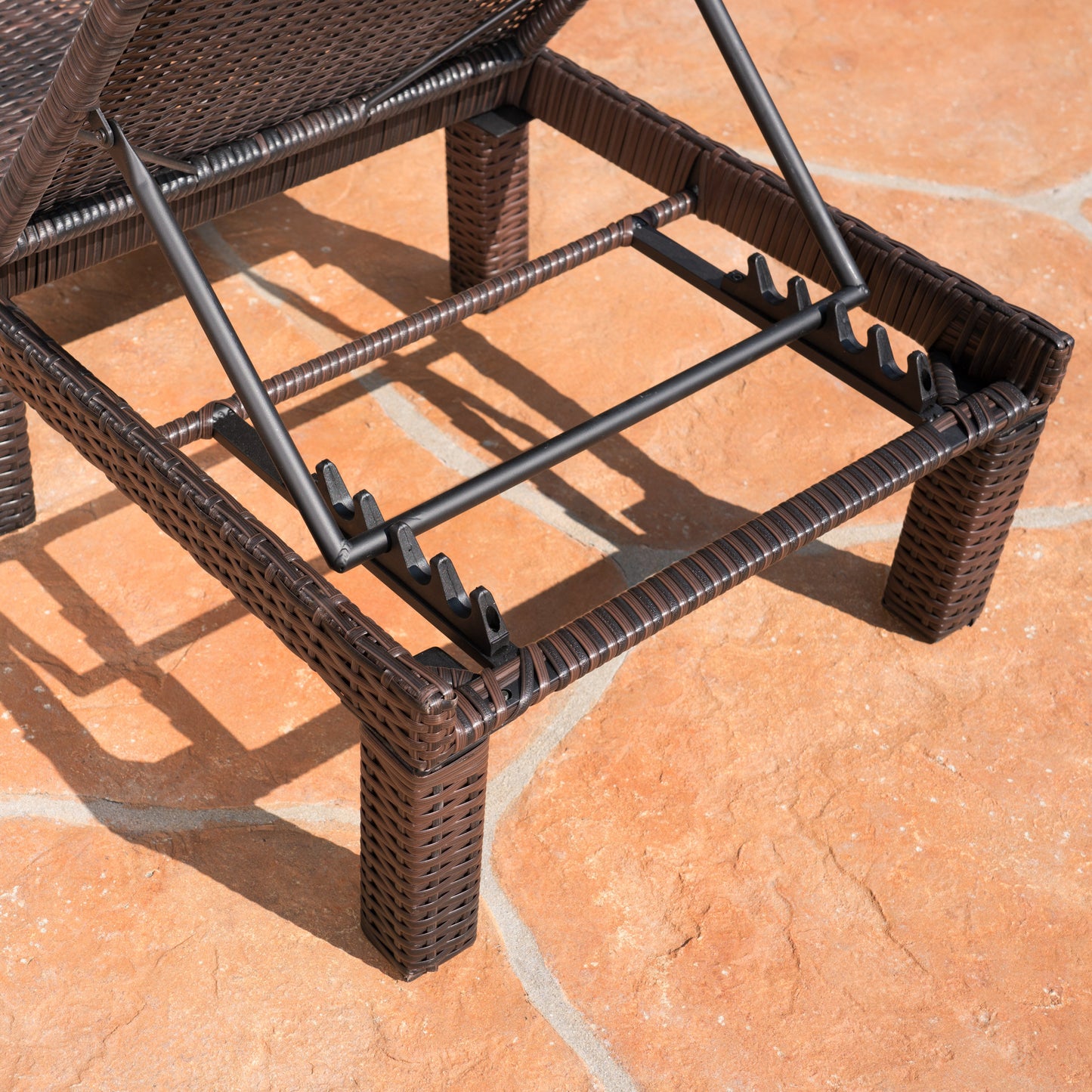Dark brown rattan chaise lounge frame with adjustable reclining mechanism