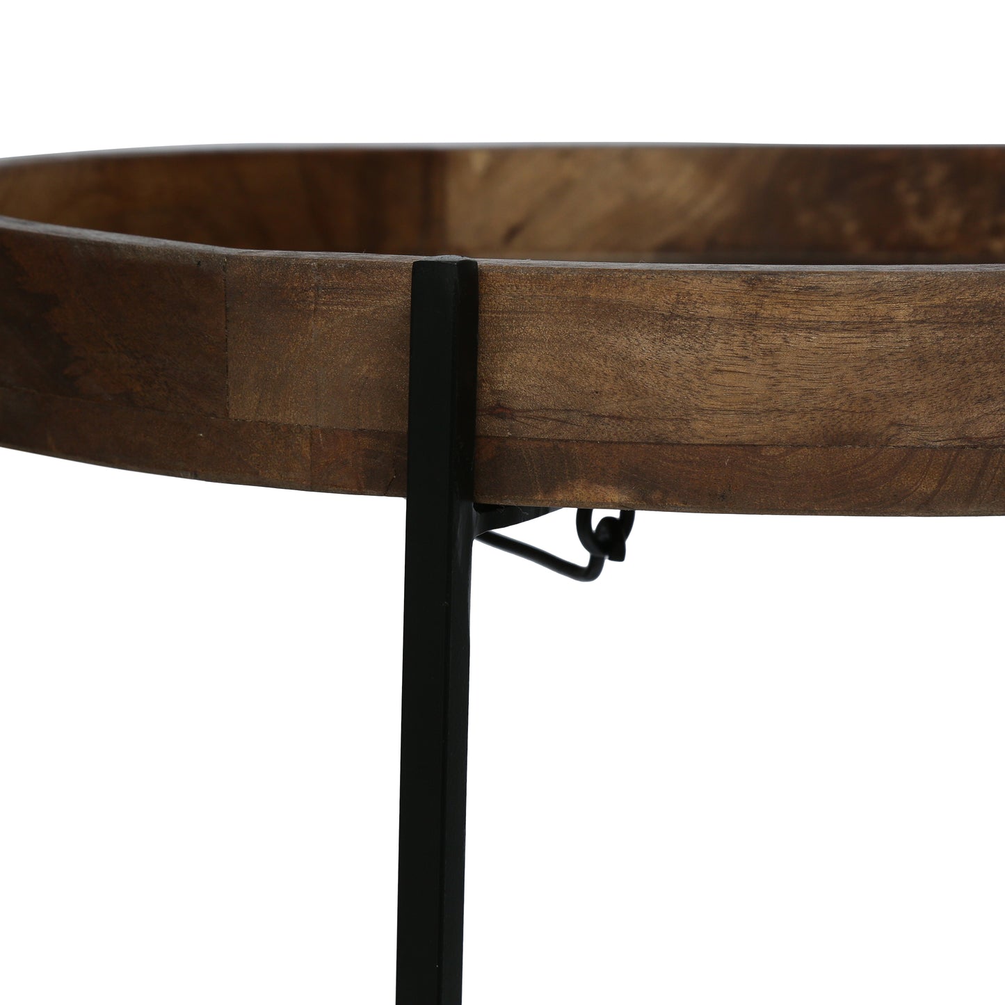 Closeup of a round wooden tray with a dark metal stand